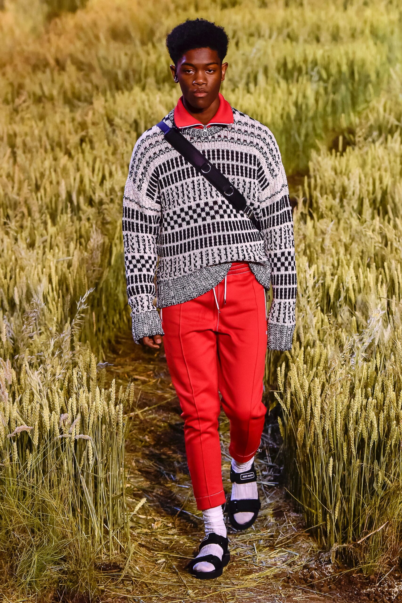 black and white striped sweater with red pants