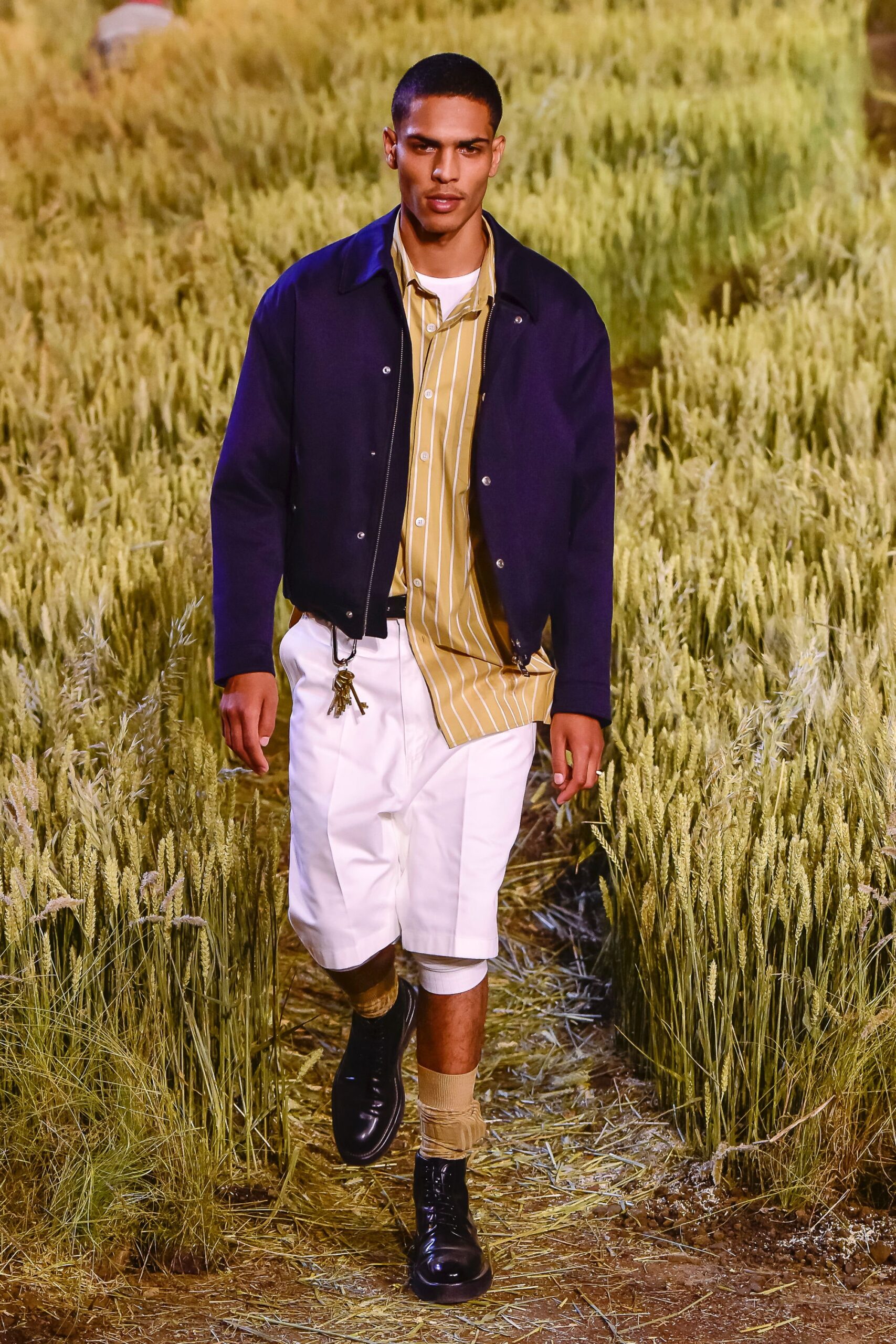 navy jacket yellow shirt white pants