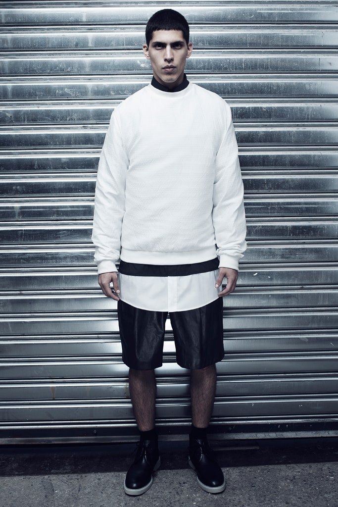 white relaxed sweater and black leather shorts