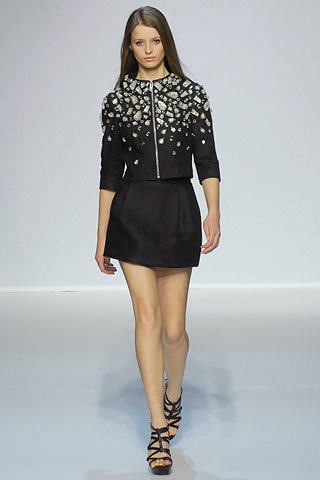 black fitted jacket and mini skirt