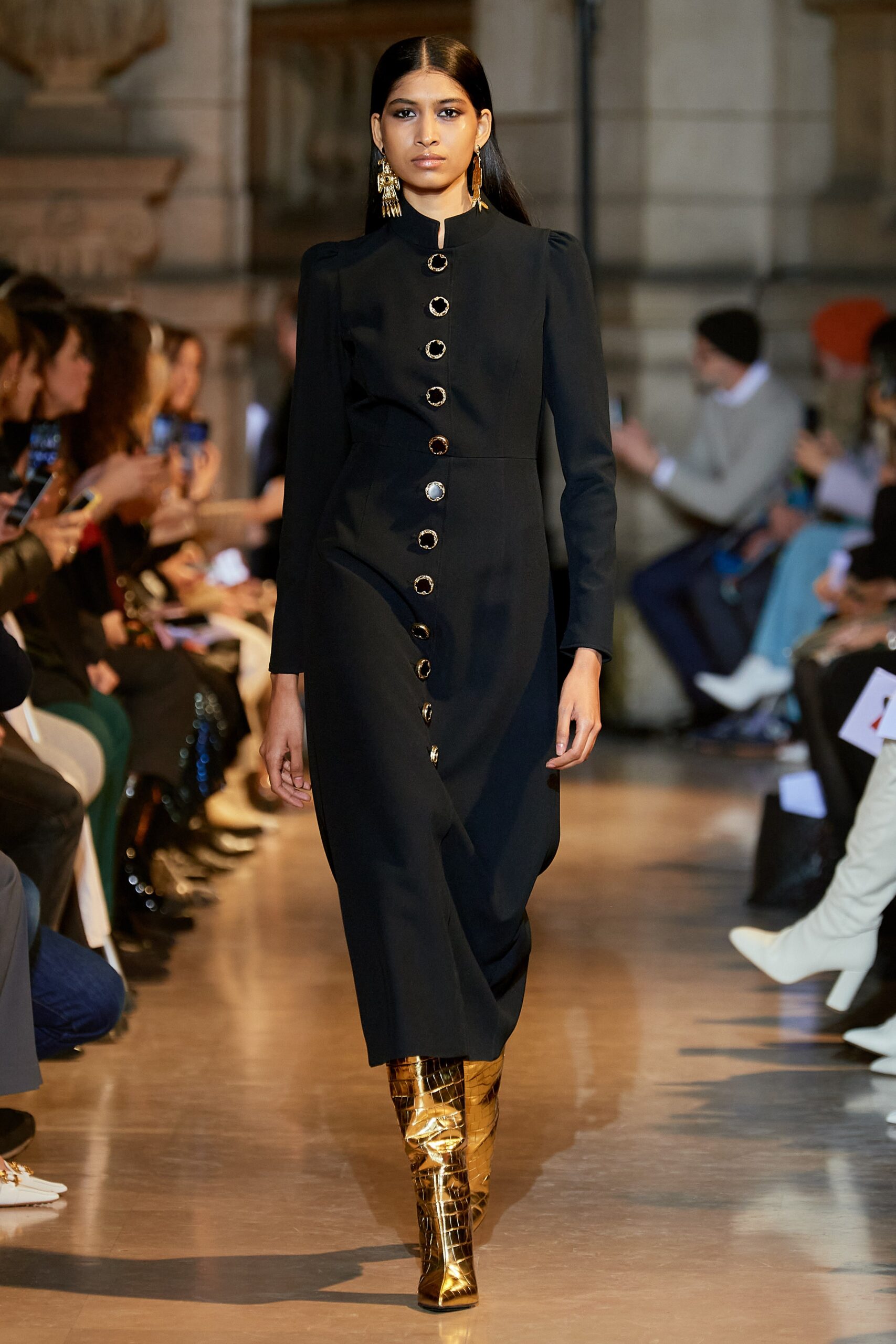 black fitted midi dress with gold boots