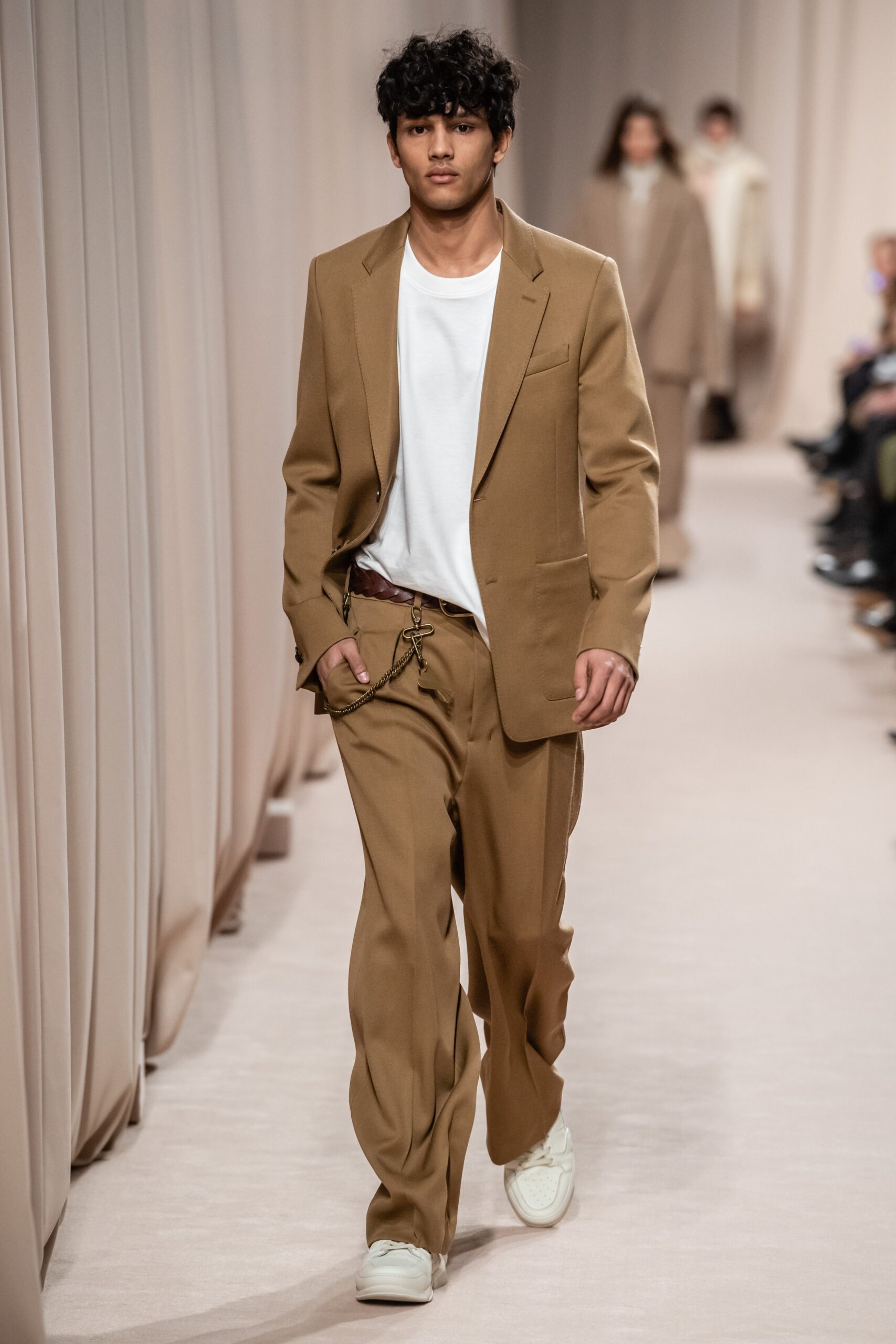 beige tailored suit with white t-shirt