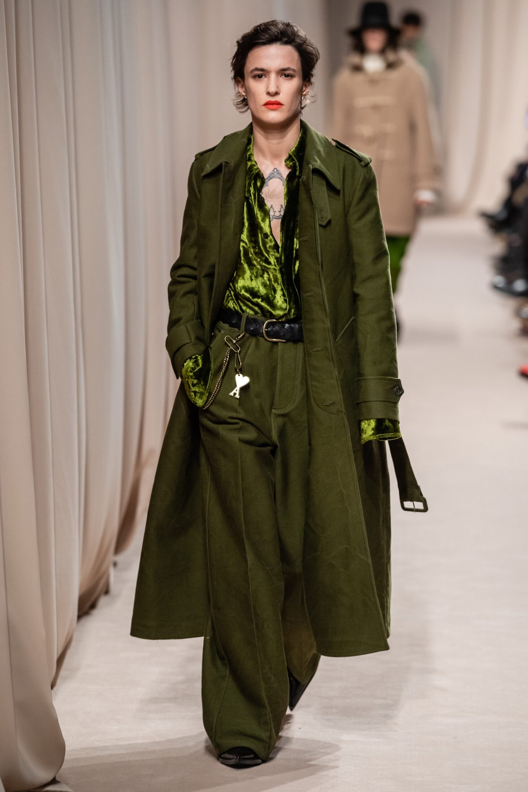 green coat with black shirt and pants