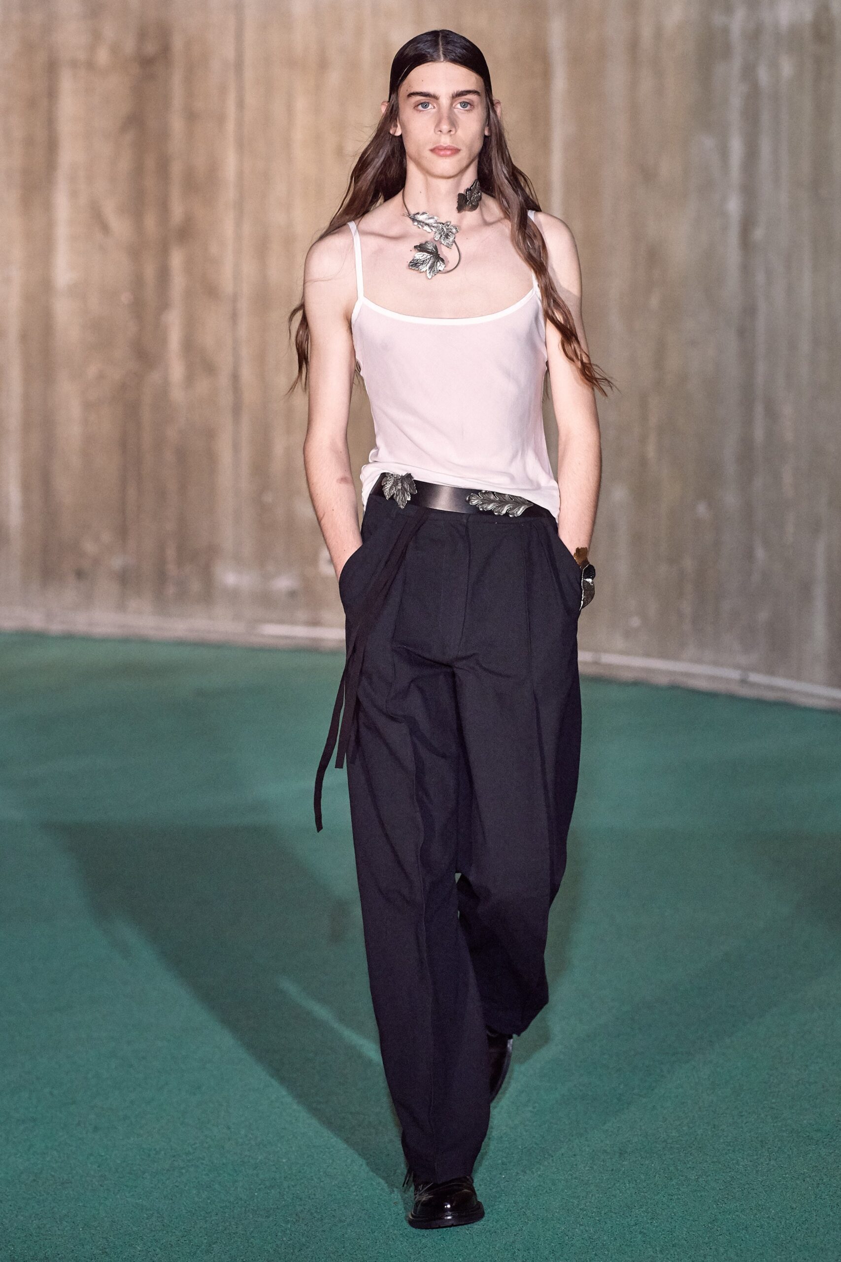 white silk sleeveless top and black relaxed pants