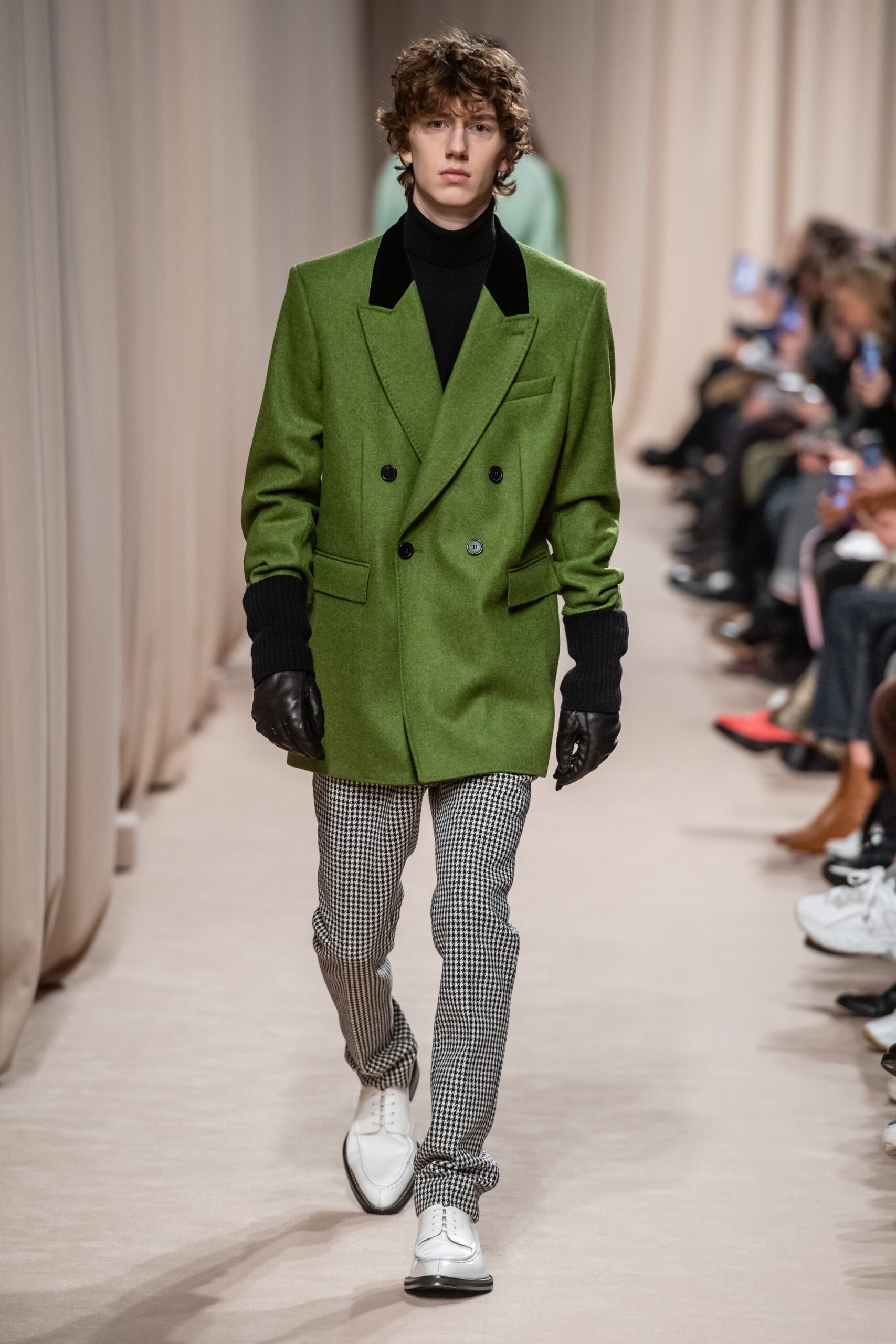 green tailored blazer with black turtleneck