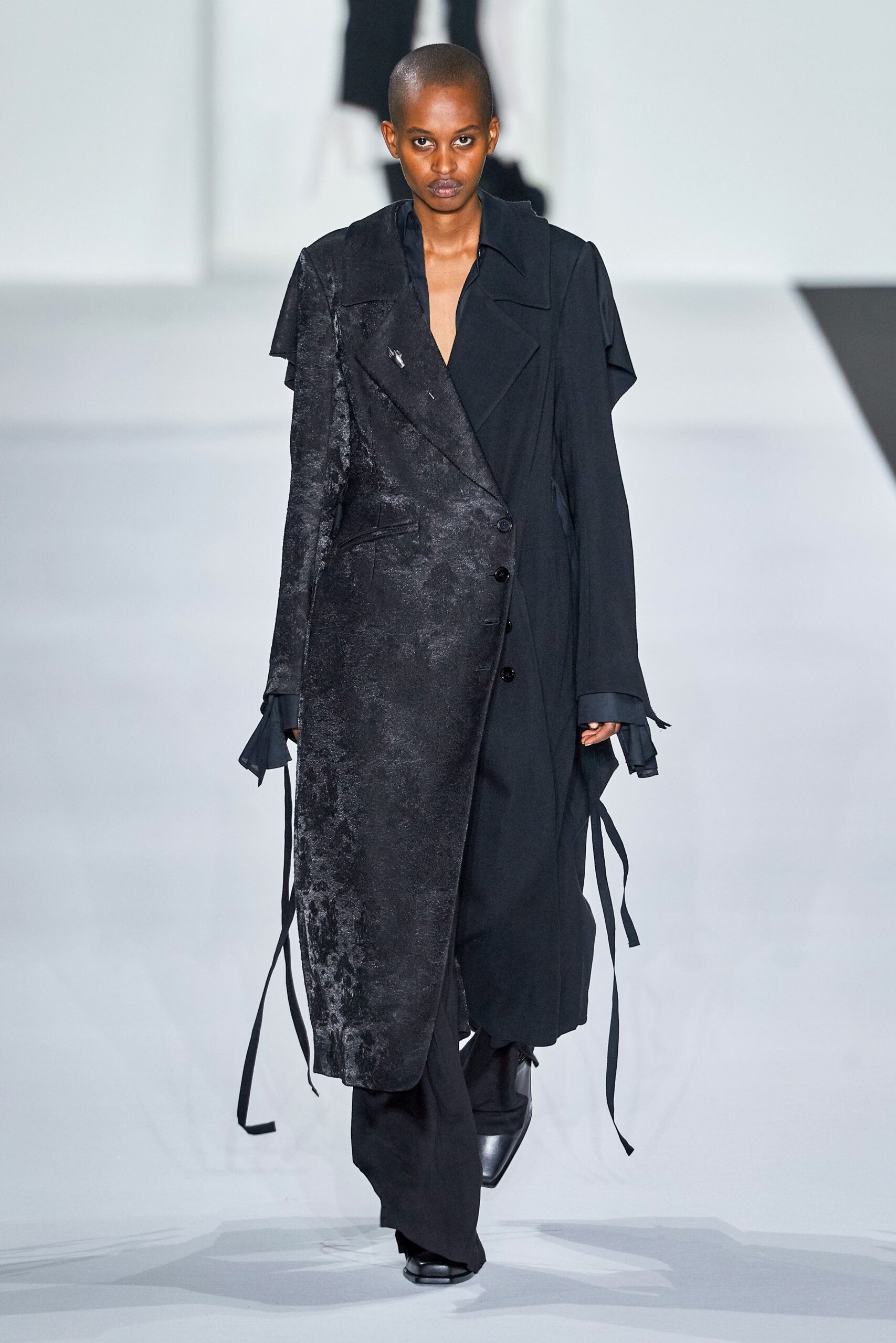 black asymmetric coat with fitted pants