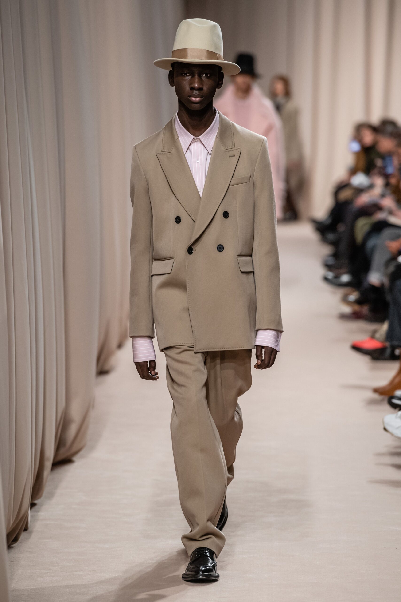 beige tailored suit with pink shirt