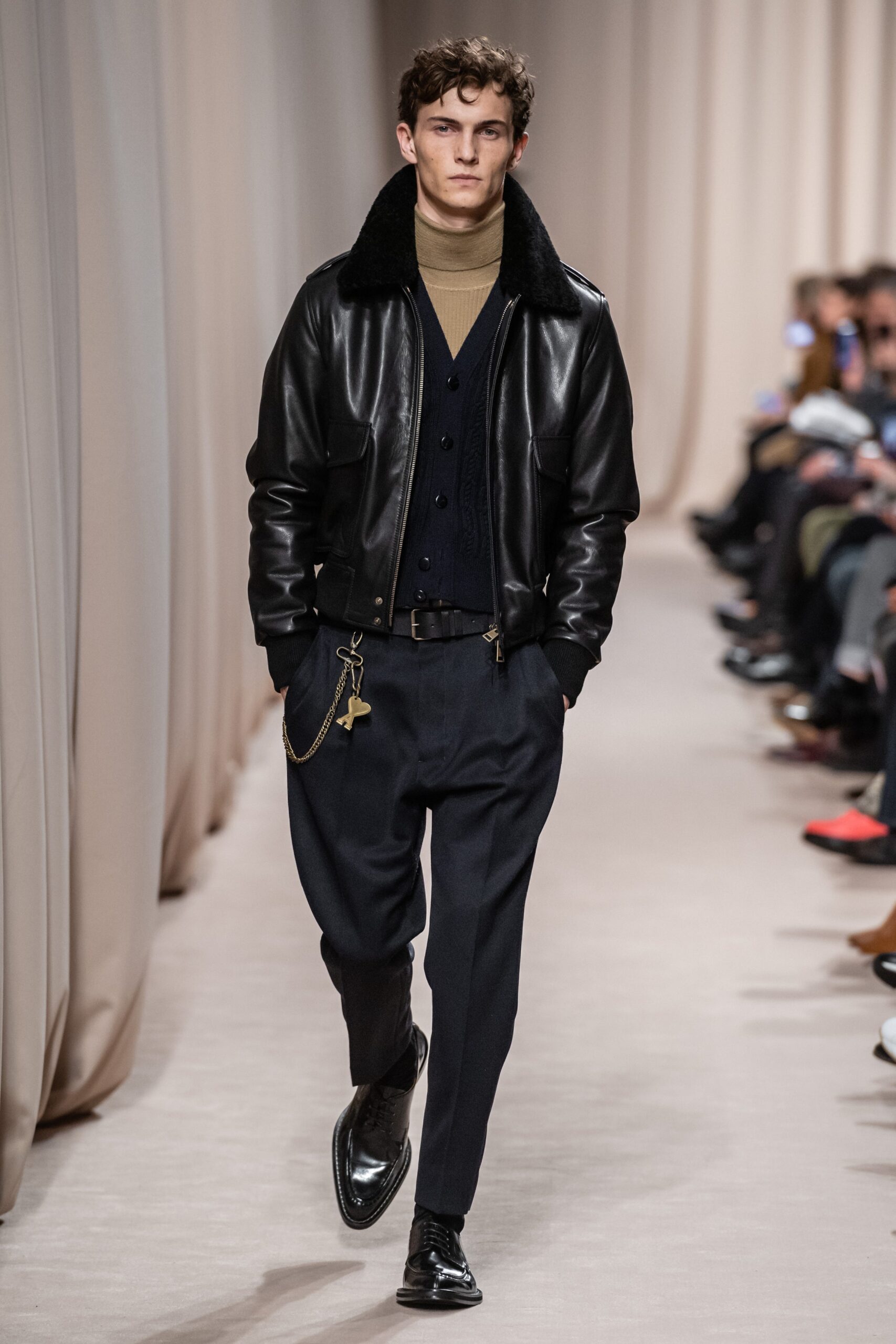 black leather jacket beige sweater