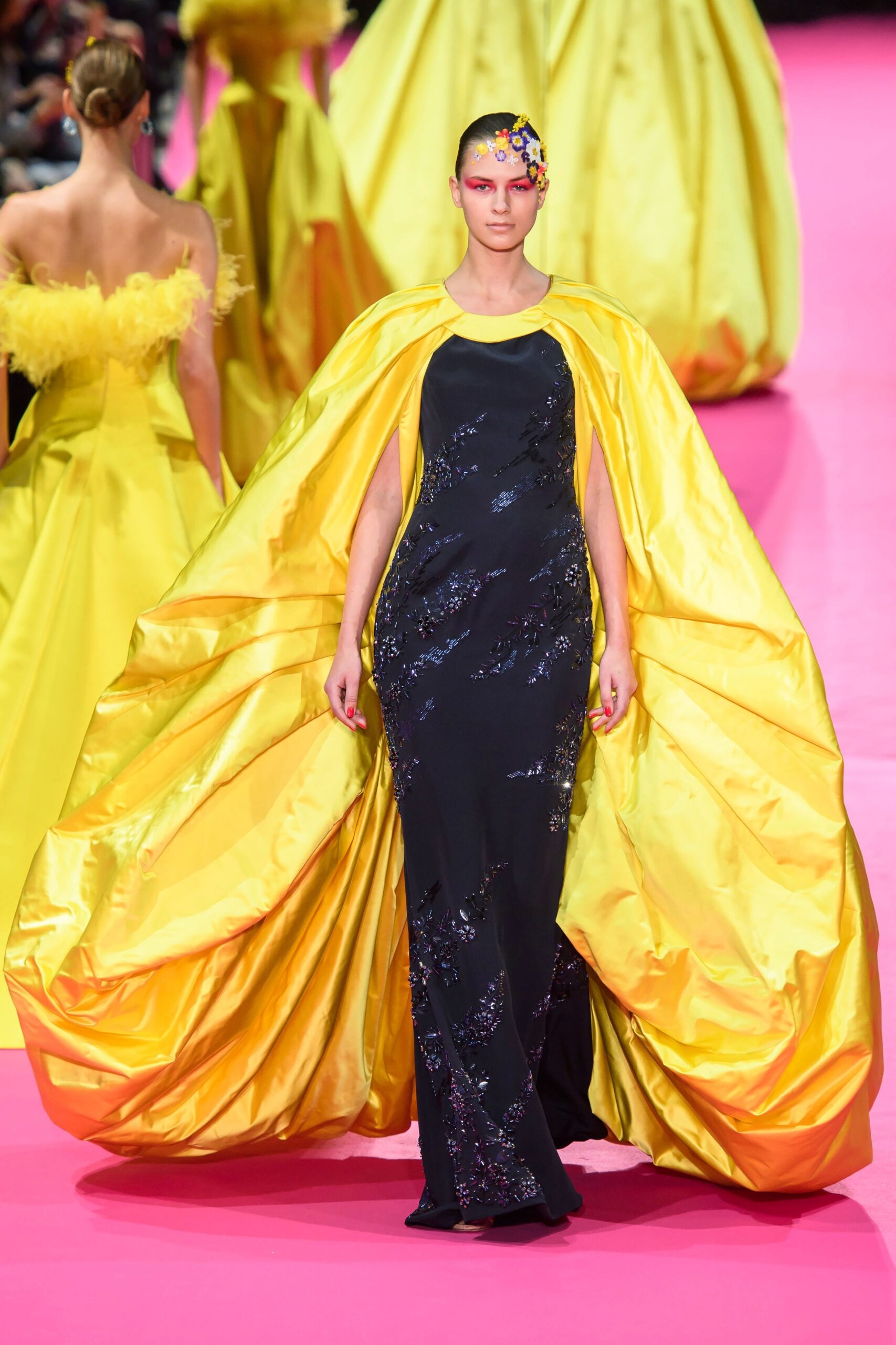 black sequined gown with yellow cape