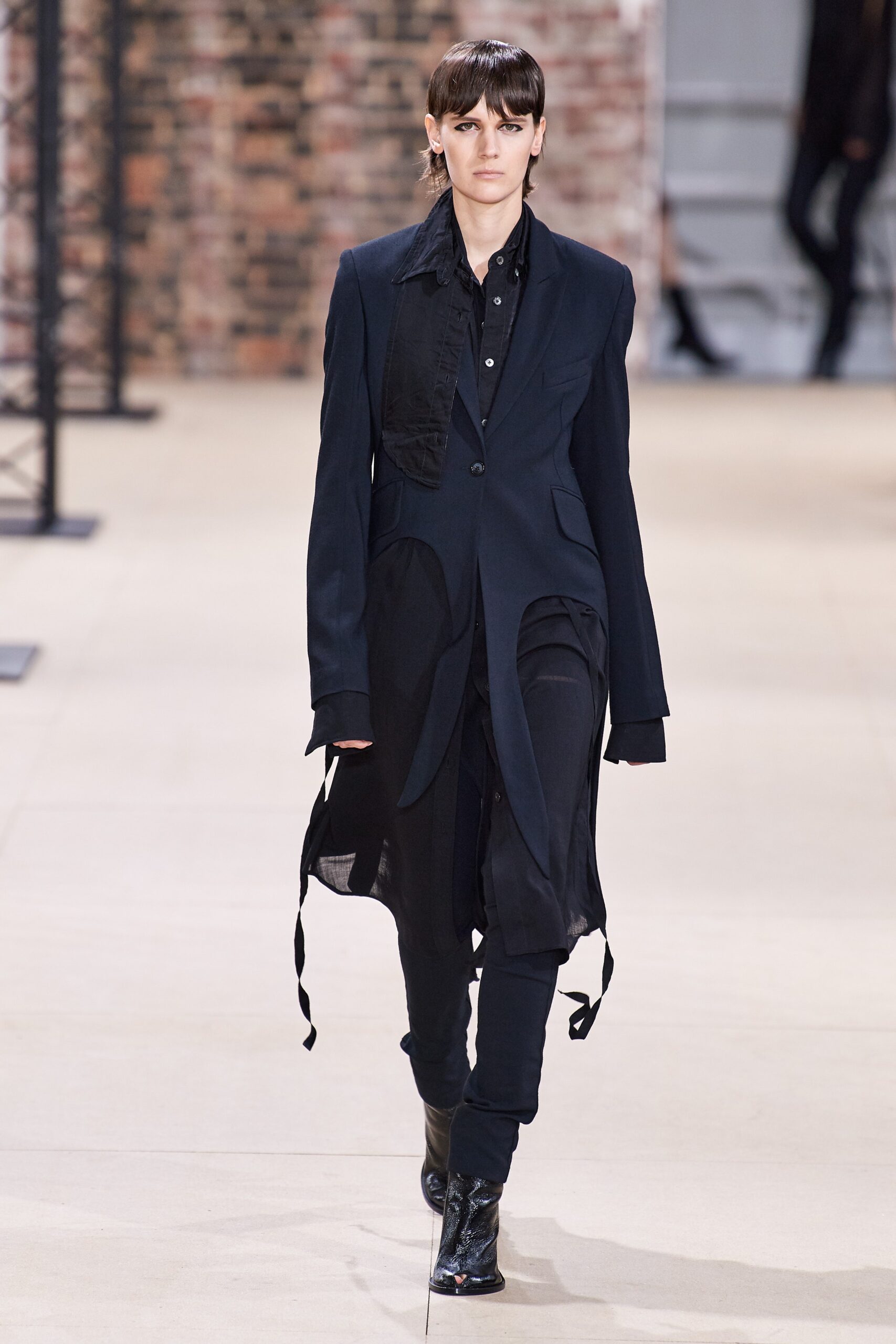 black fitted coat and slim pants