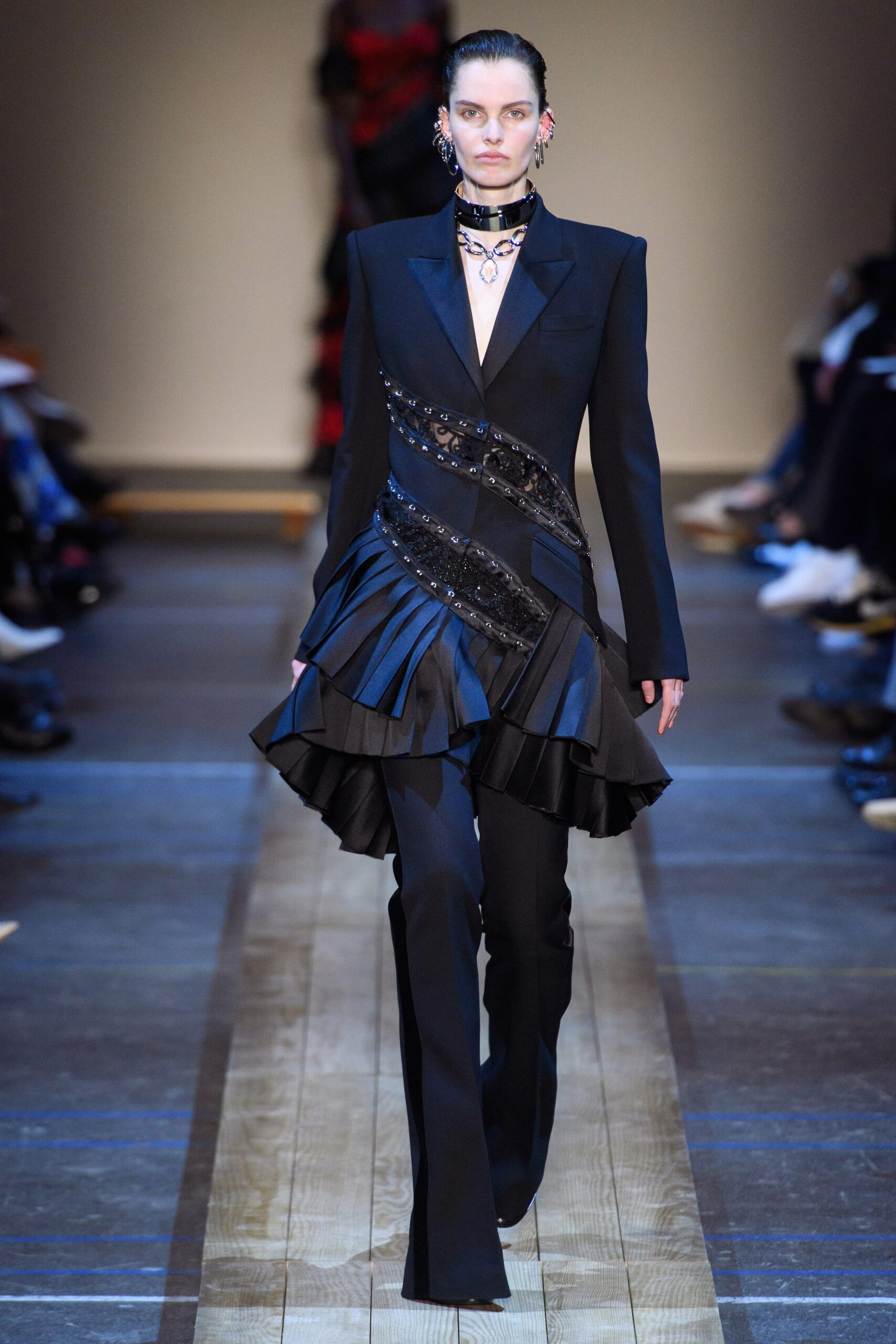 black fitted blazer with pleated skirt