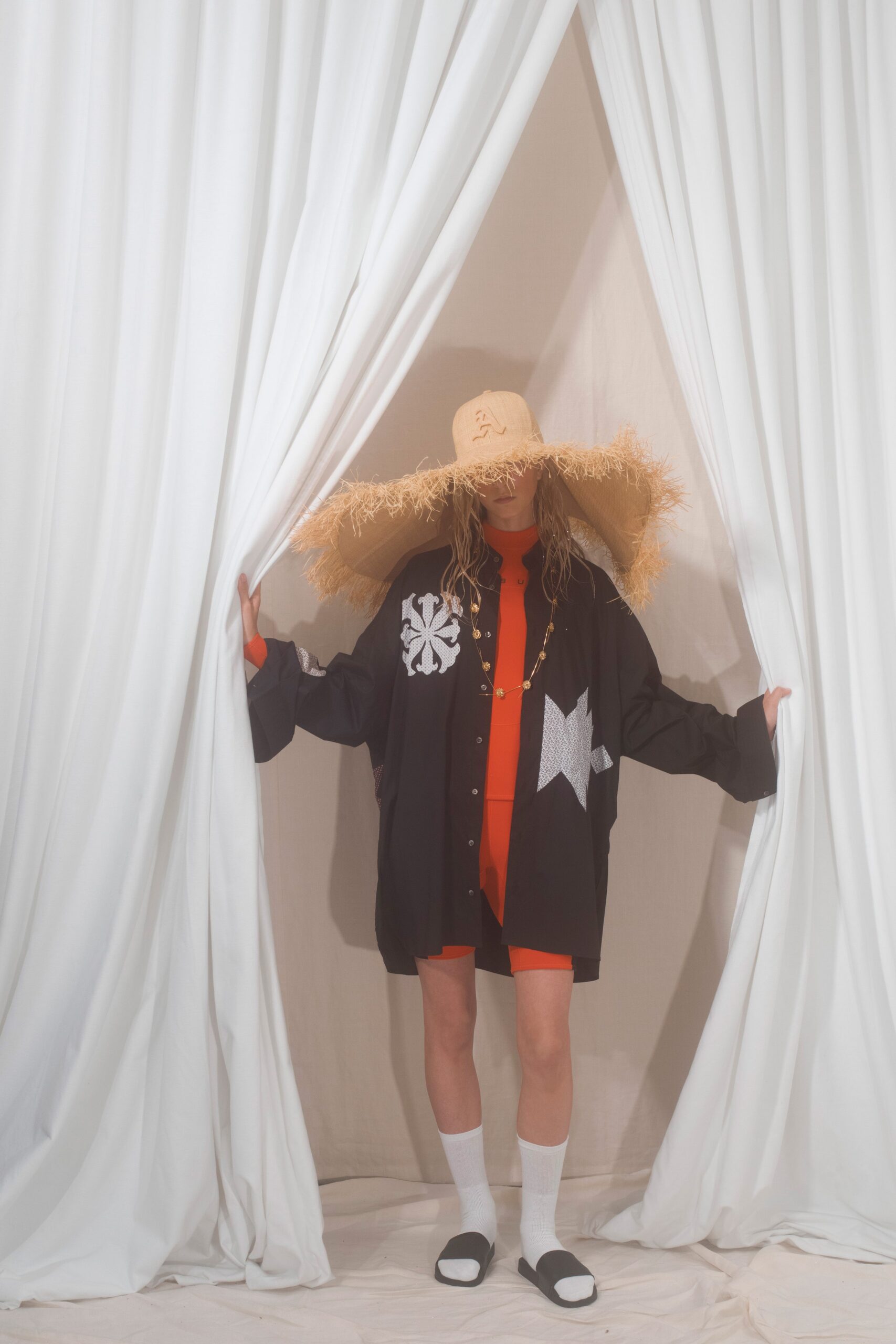 oversized black shirt with red bodysuit