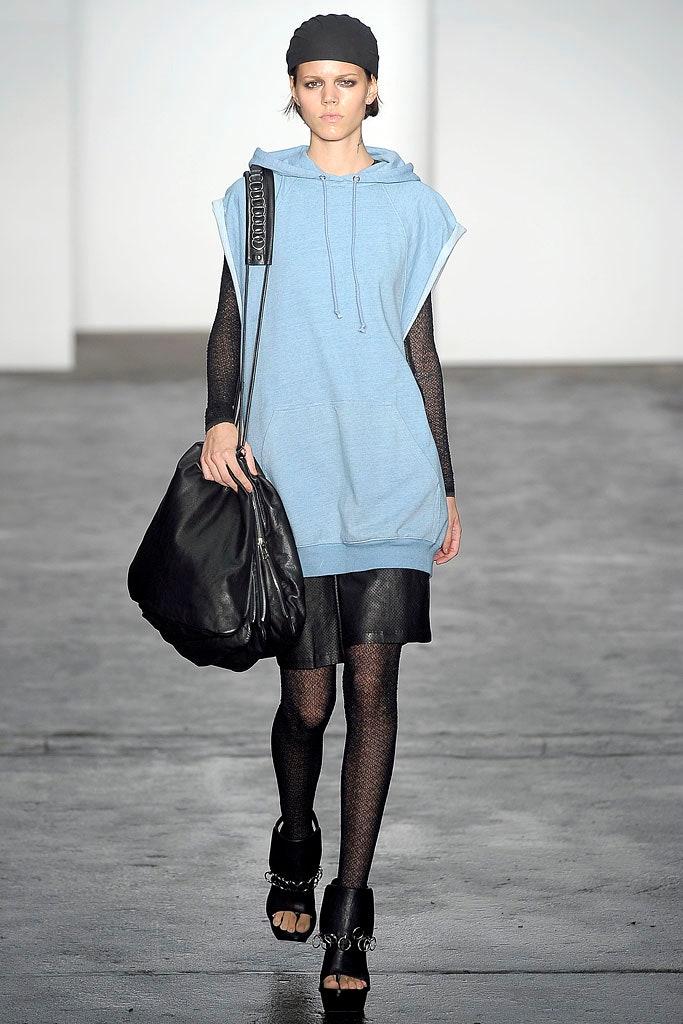 blue sleeveless hoodie with black leather skirt