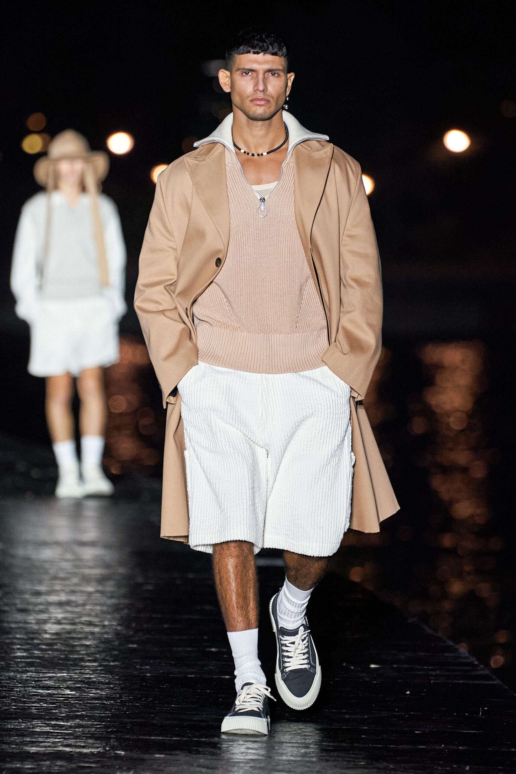 beige coat brown sweater white shorts