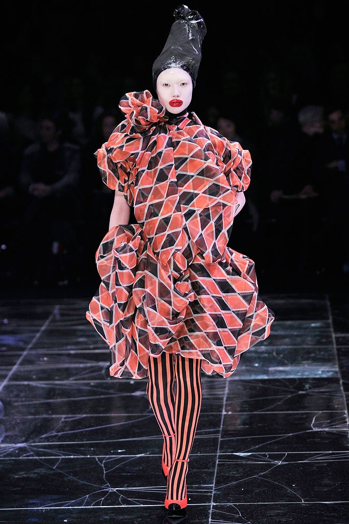 red and black pleated dress with striped leggings
