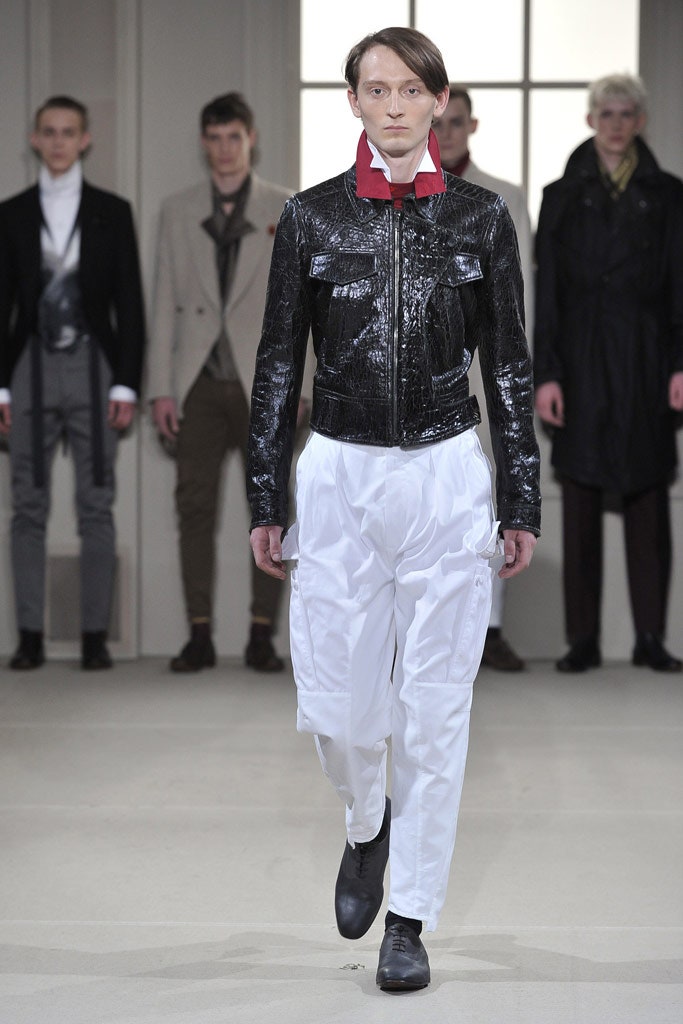 black leather fitted jacket and white cargo pants