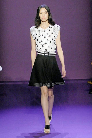 polka-dot top and black skirt