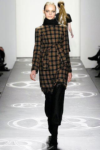 checked black and orange coat with relaxed pants
