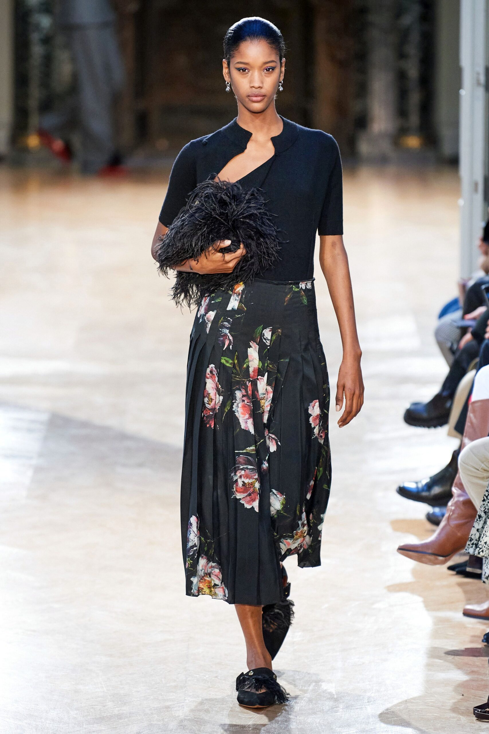 black fitted top and pleated skirt