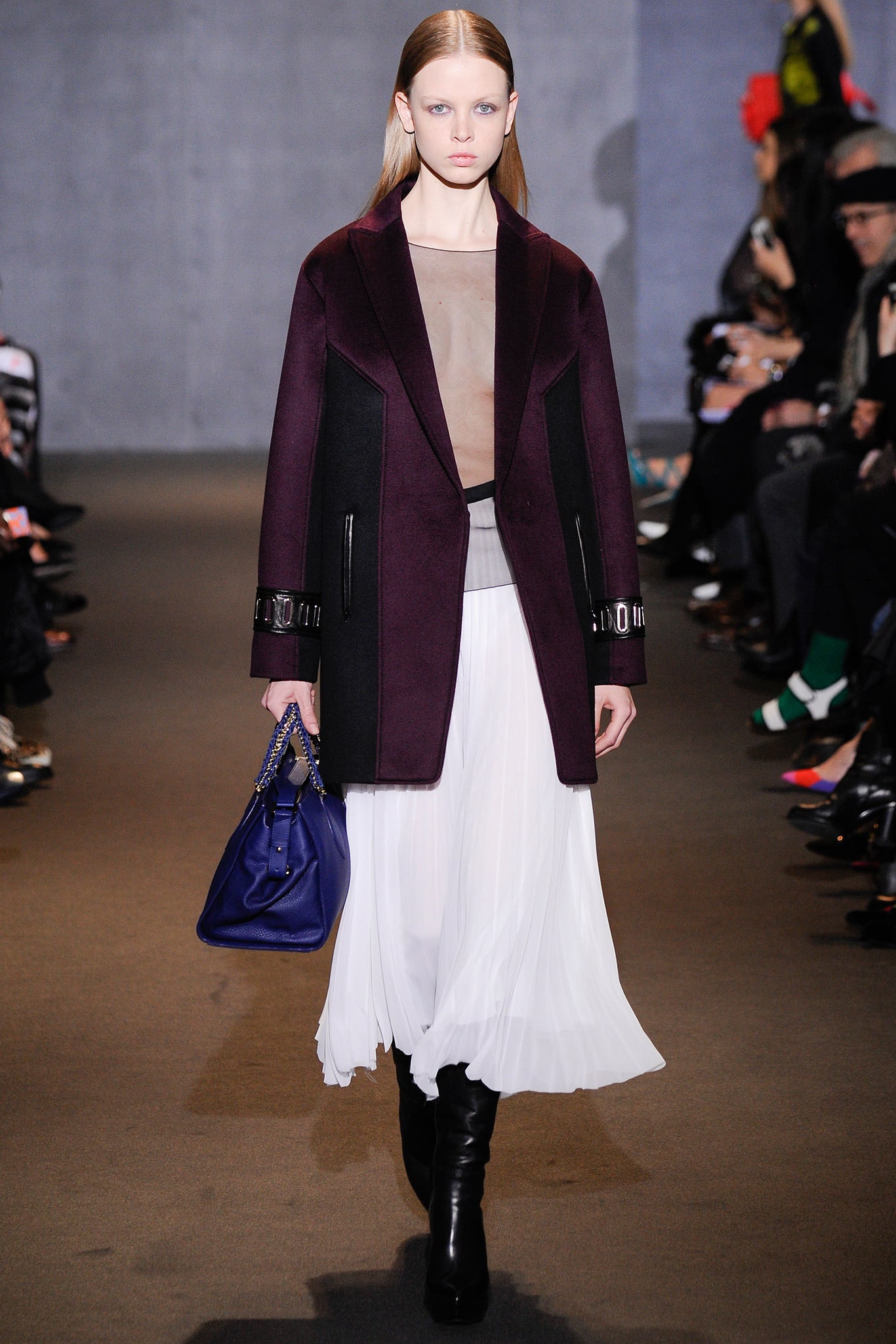 structured purple coat and white pleated dress
