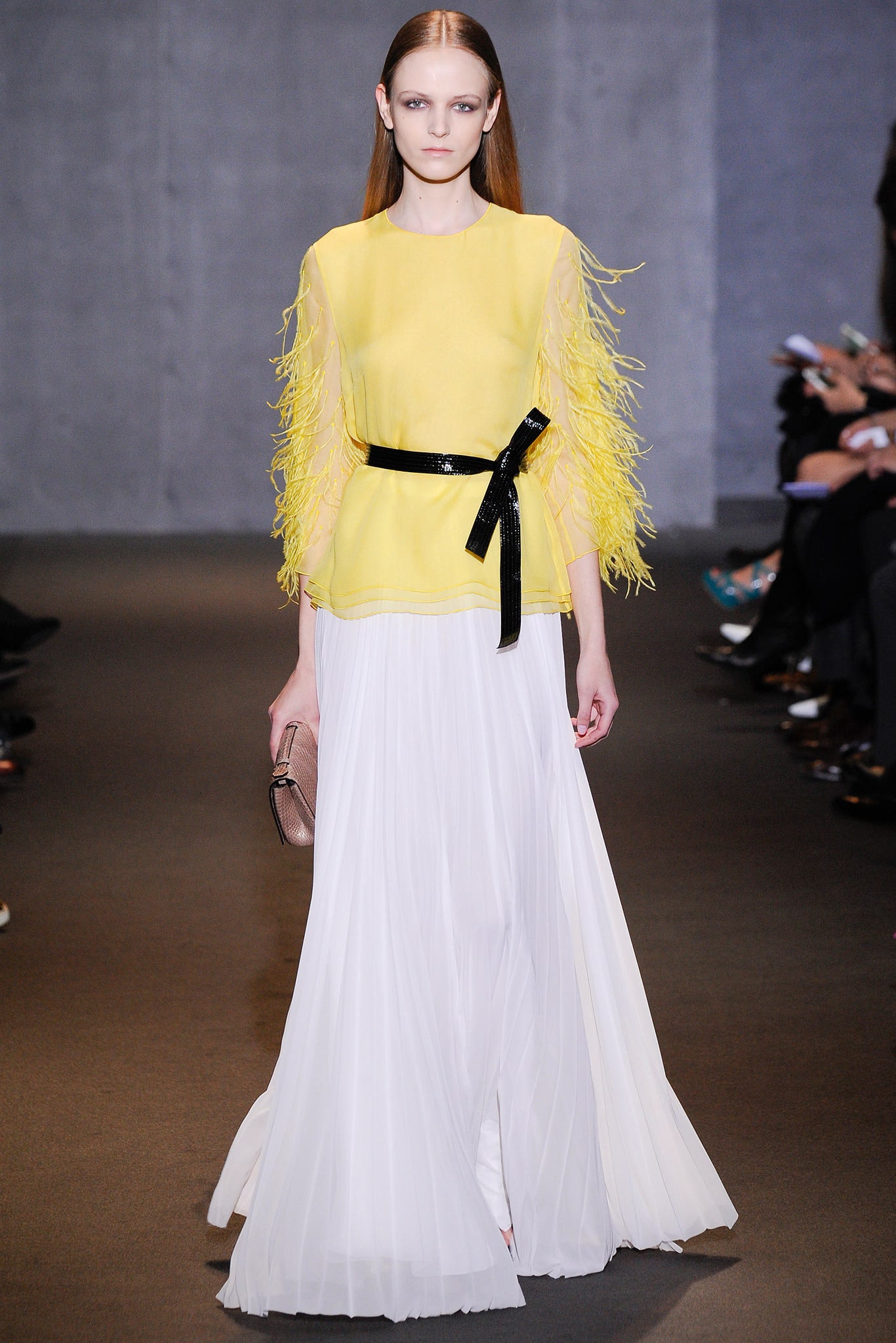 yellow fringed top with white pleated skirt