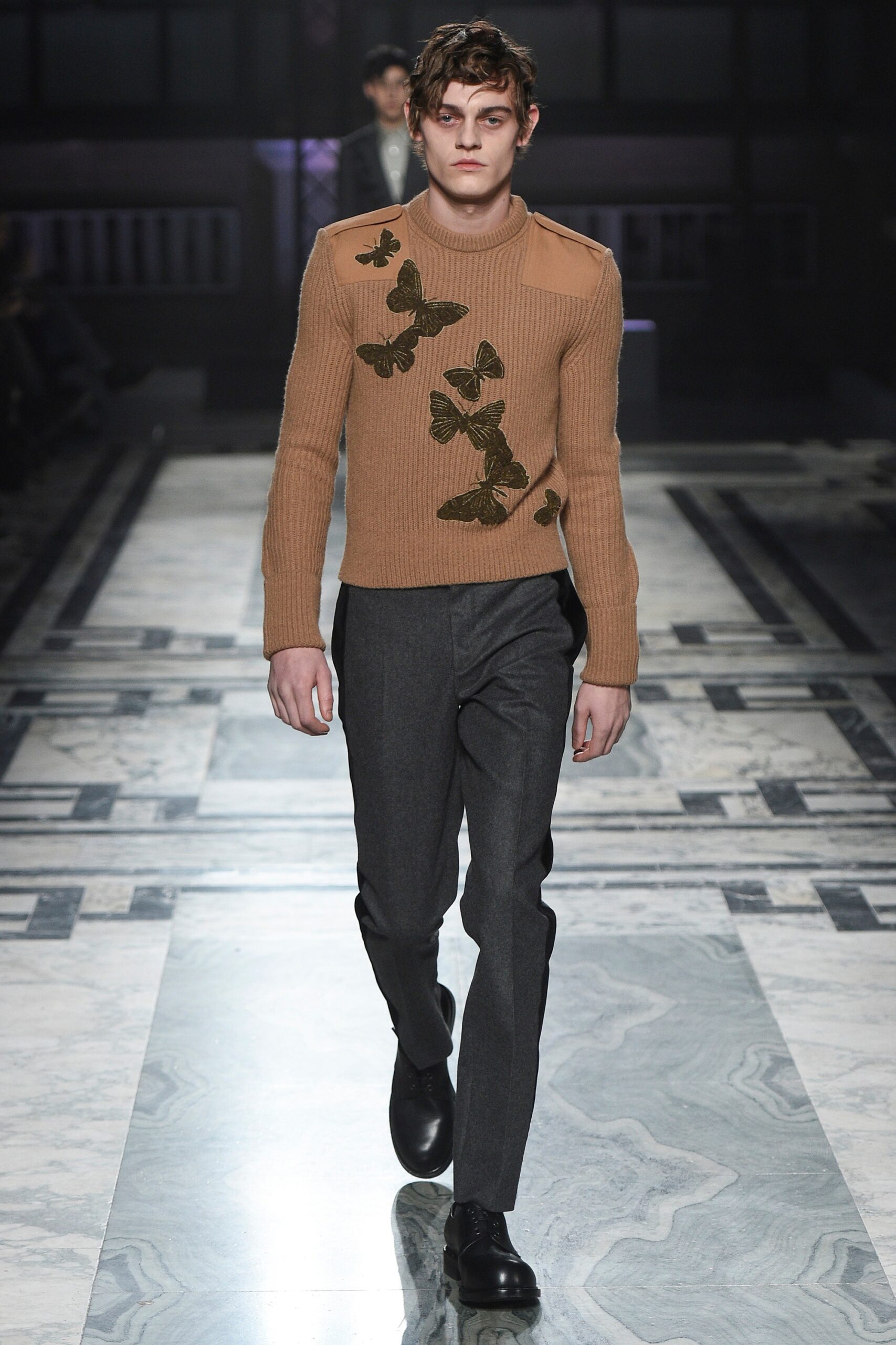 brown embroidered sweater with gray pants