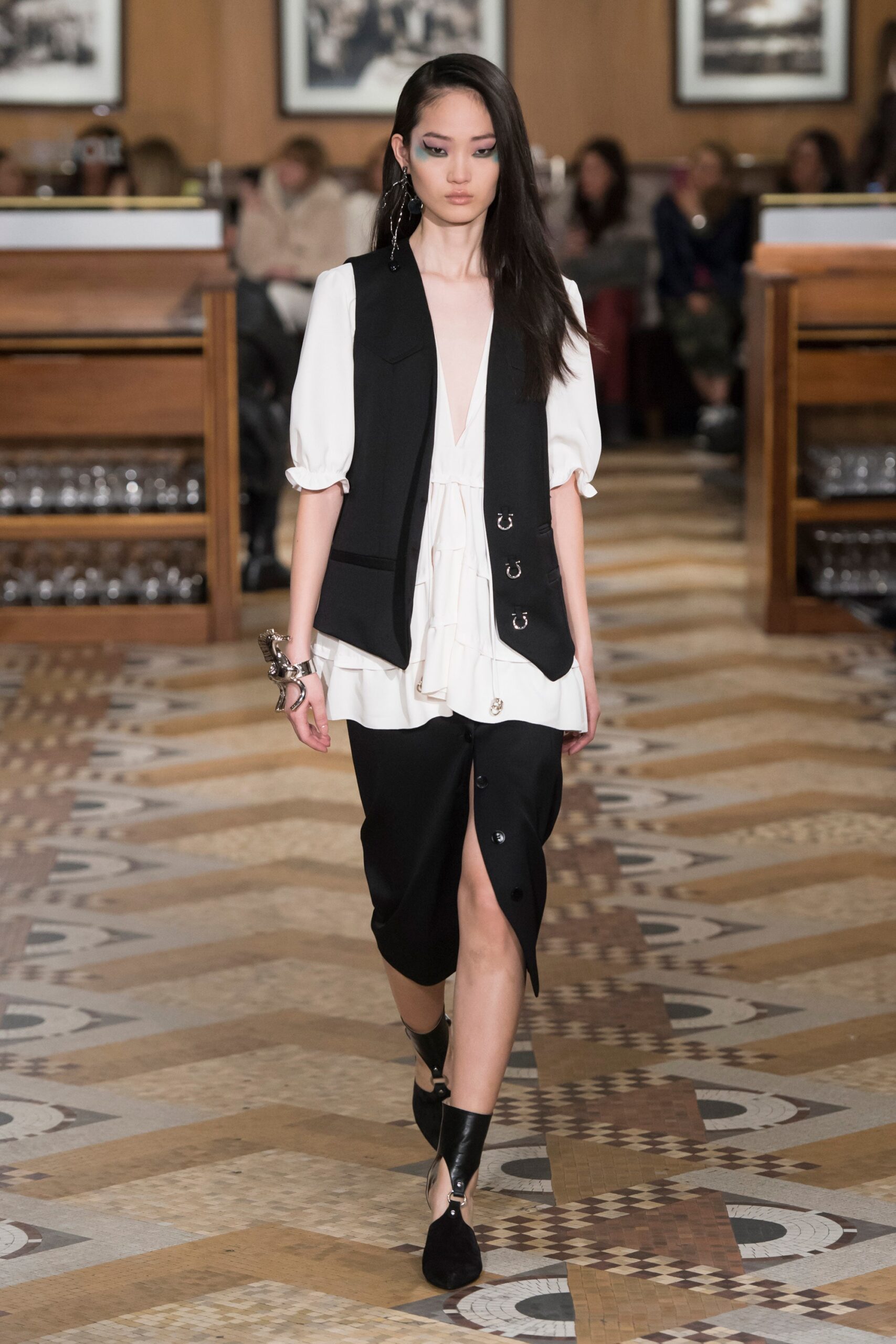 black vest white blouse black skirt