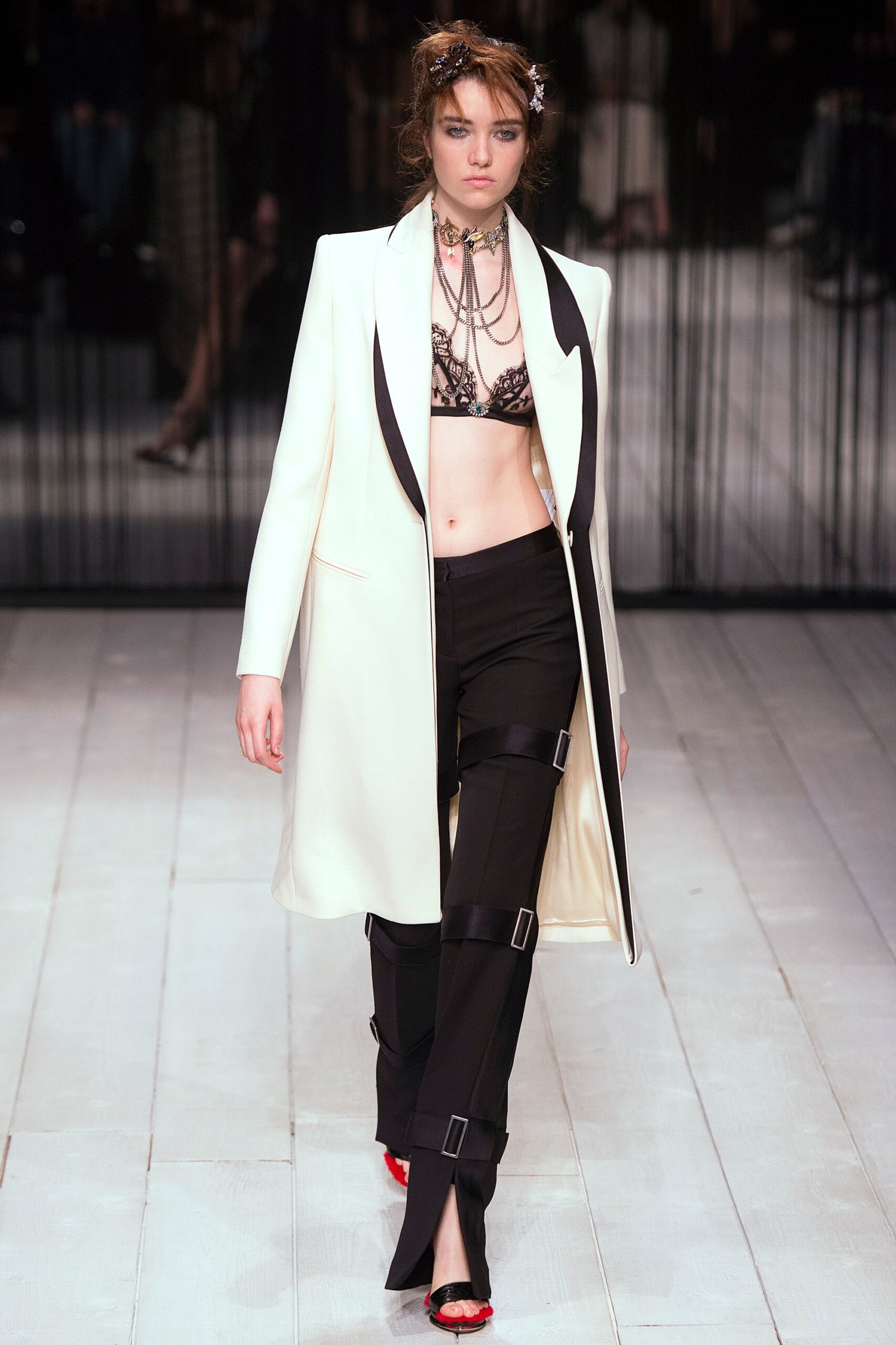 white tailored coat with black lace bra