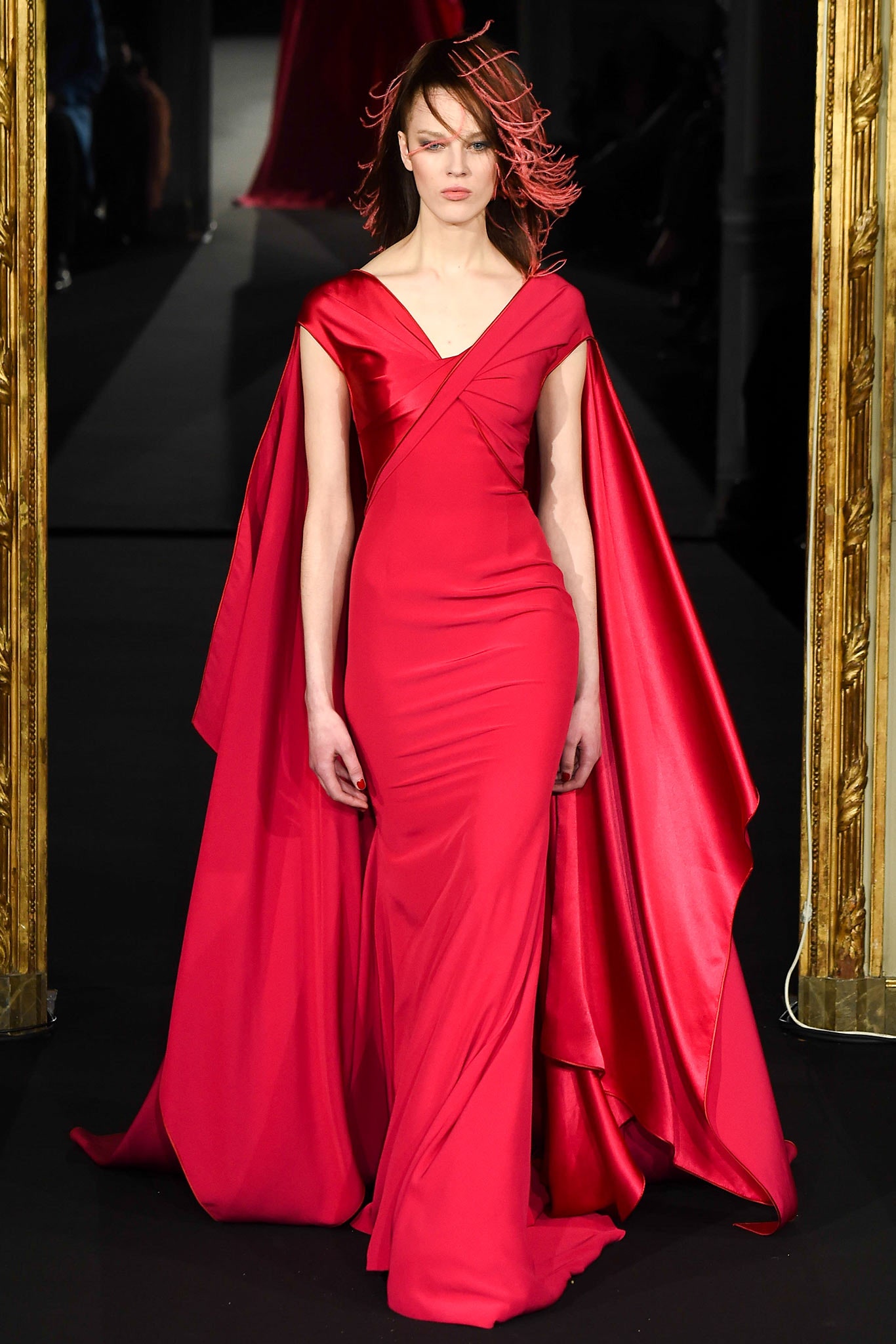 red satin sleeveless v-neck fitted draped flowing gown
