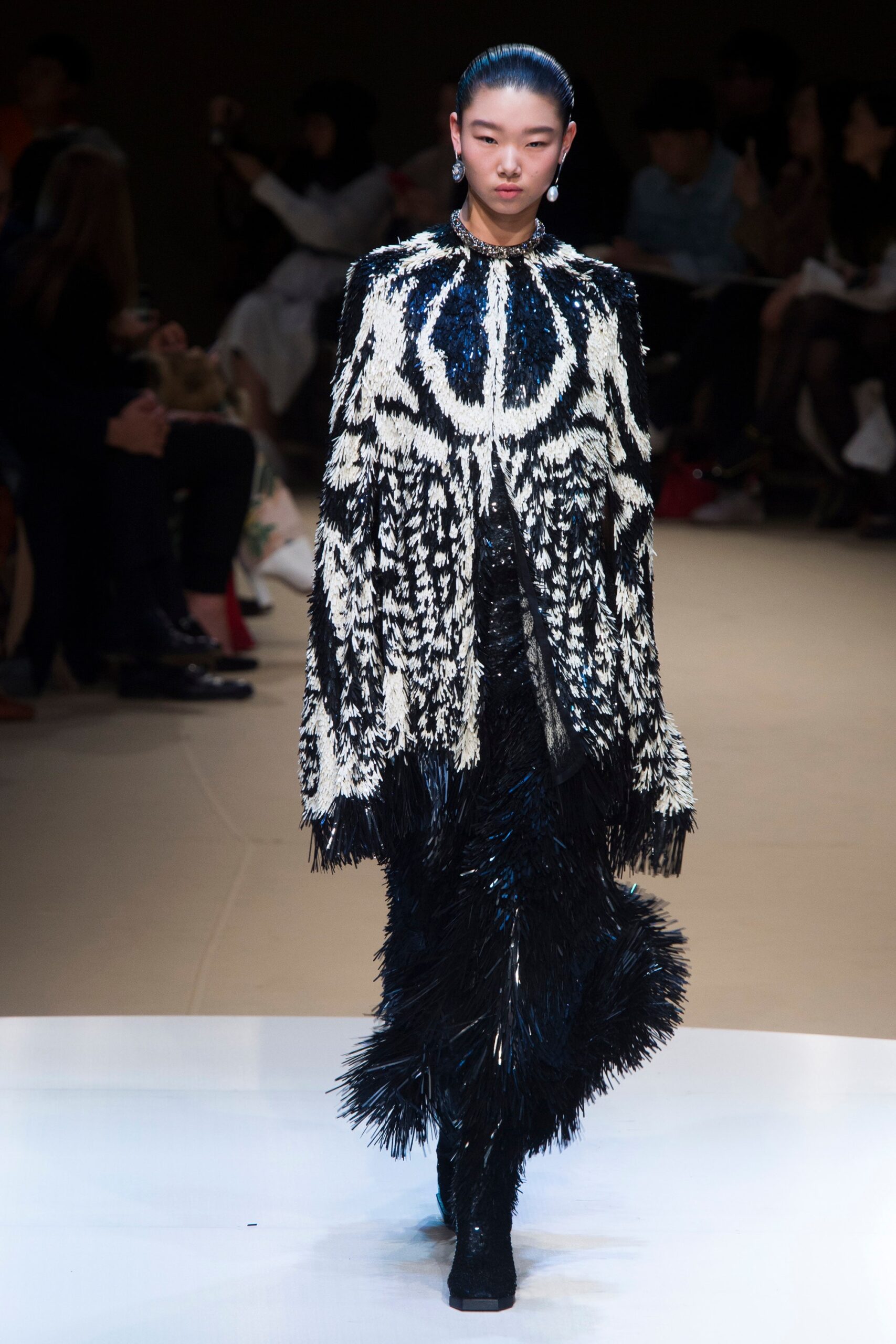 black and white fringed cape with fitted pants