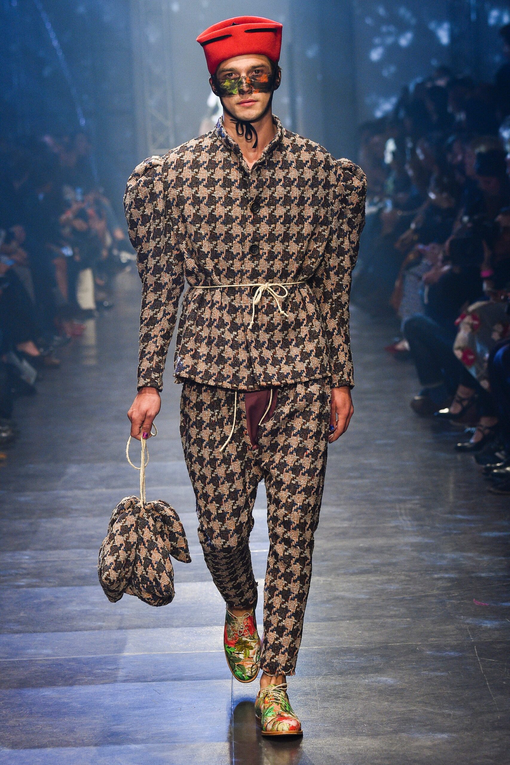 brown checked suit with red hat