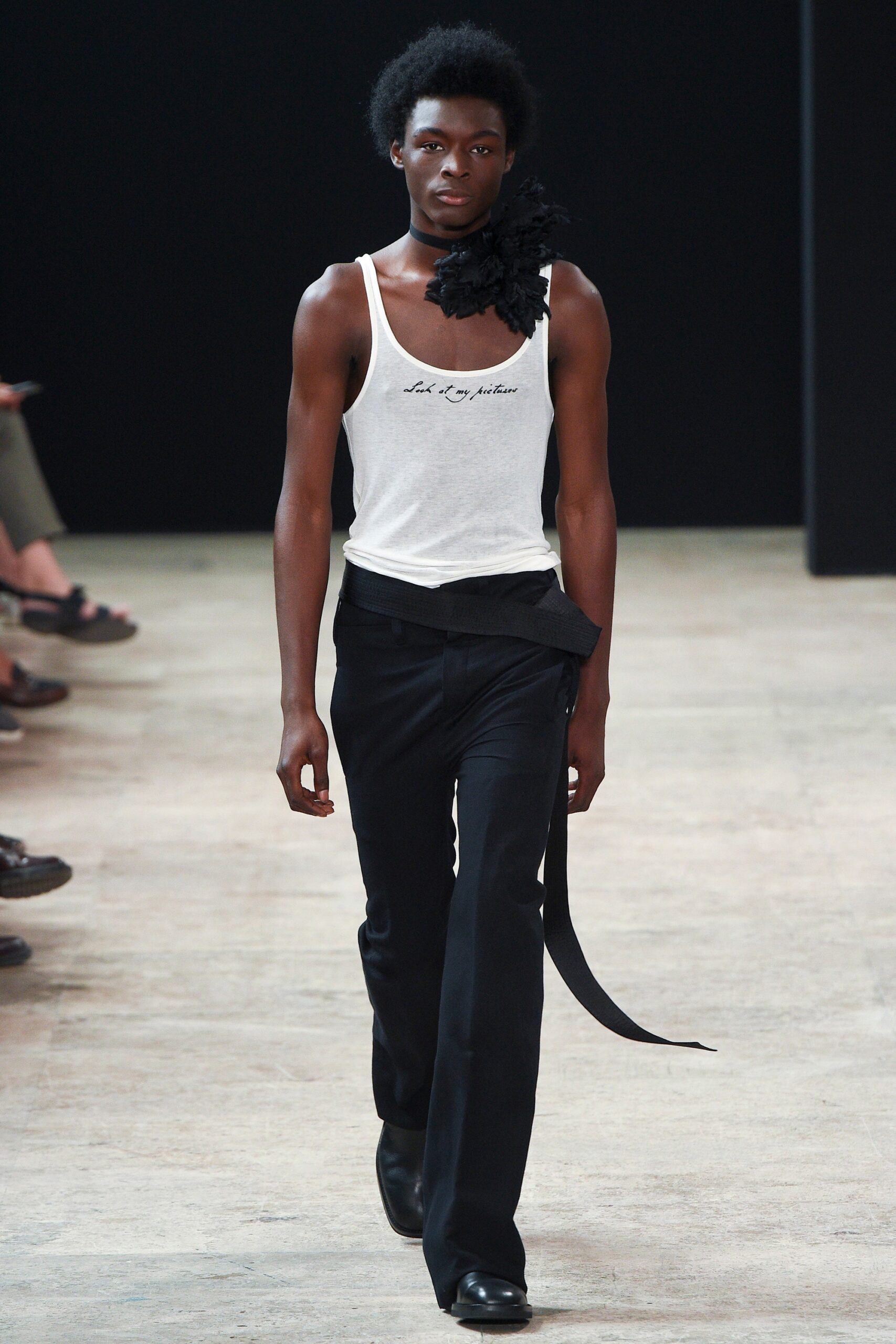 white fitted tank-top and black tailored pants