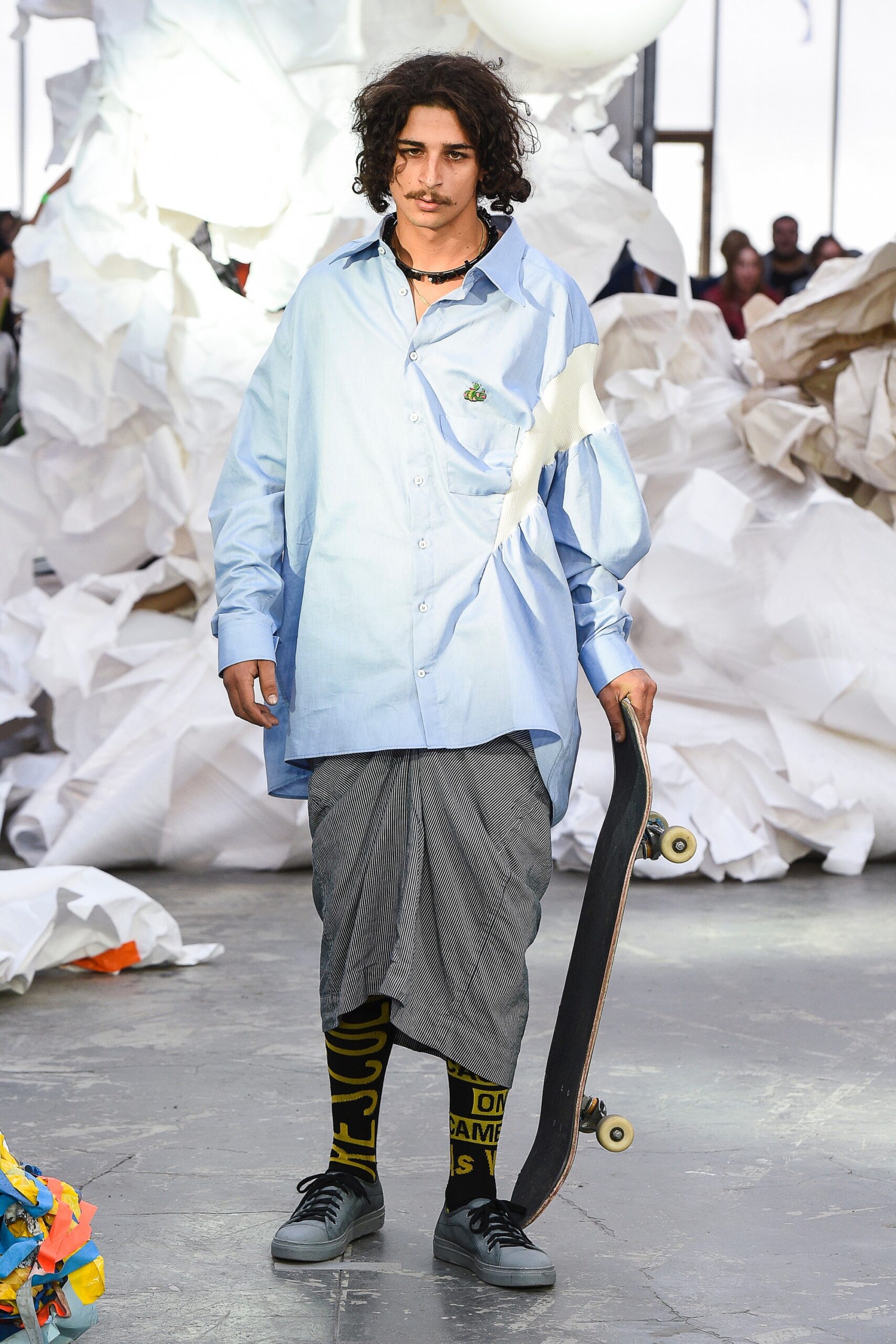 oversized blue shirt with pleated gray skirt