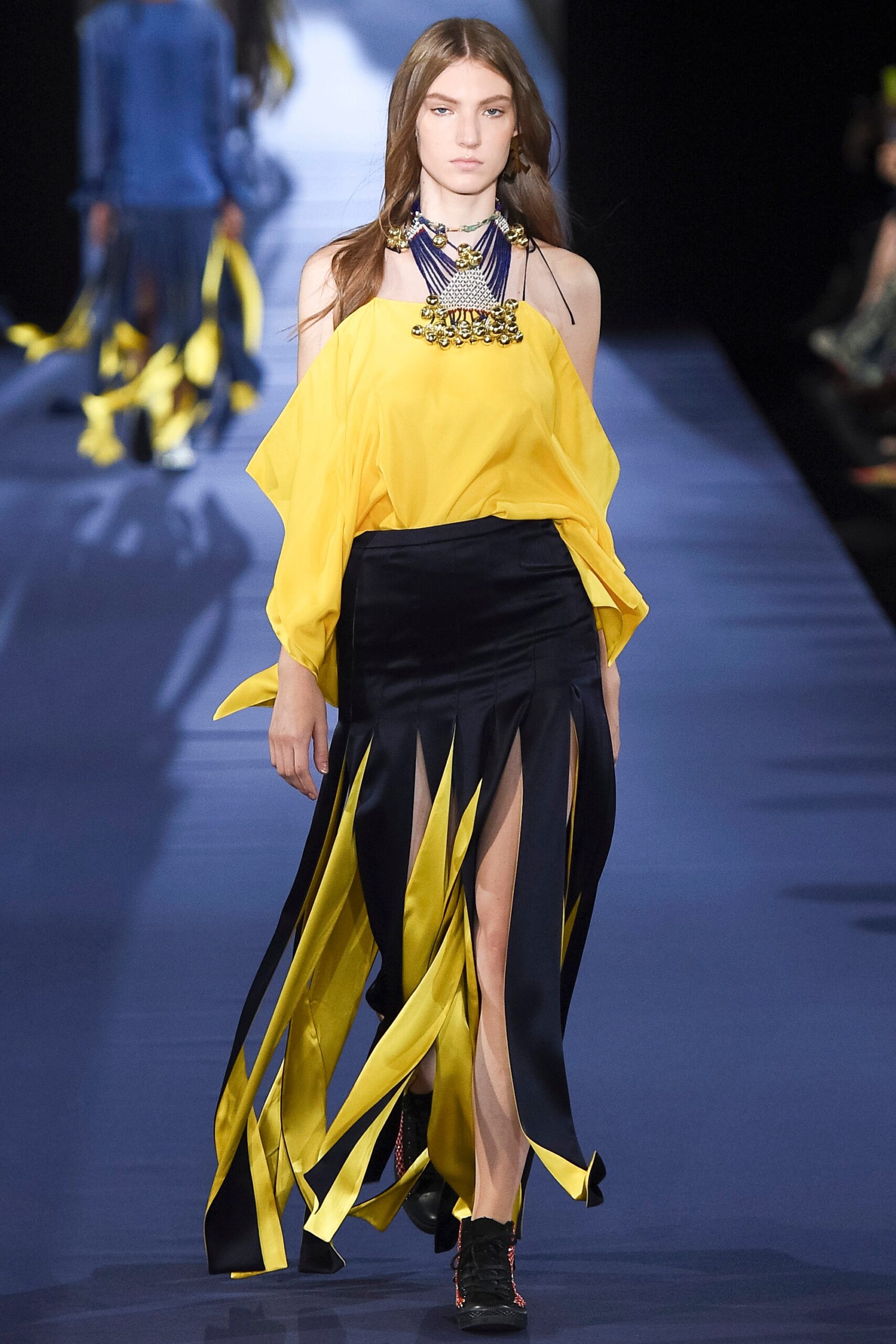 yellow off-shoulder top and black slit skirt