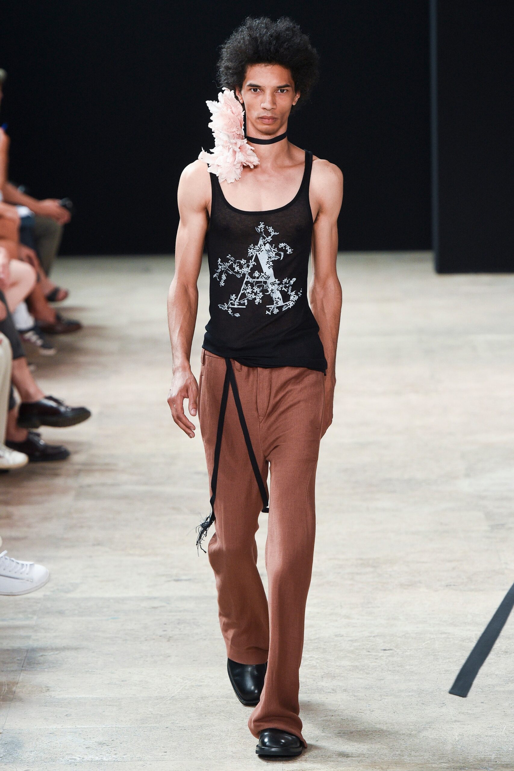 black tank-top and brown pants