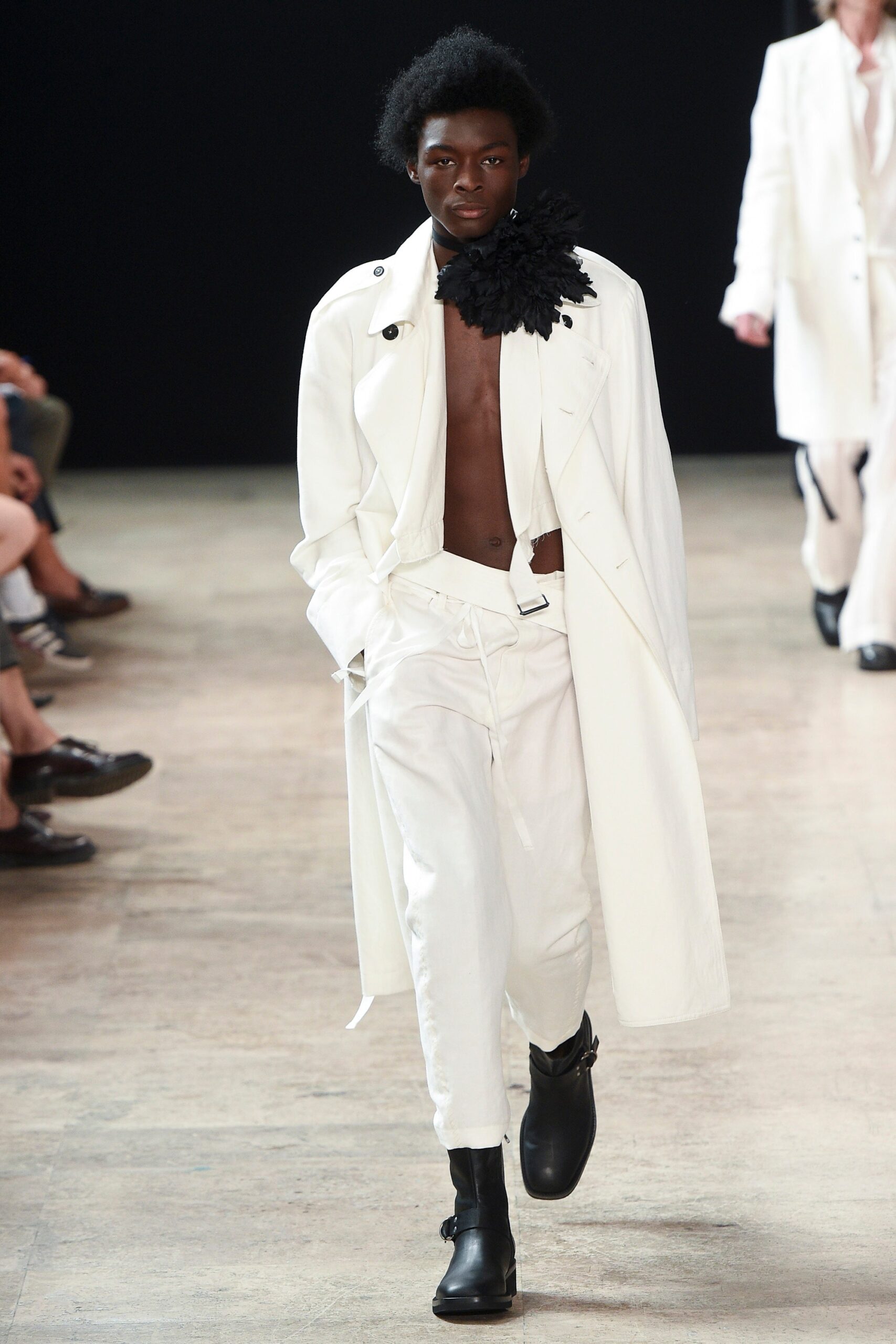 white relaxed coat with black ruffled accessory