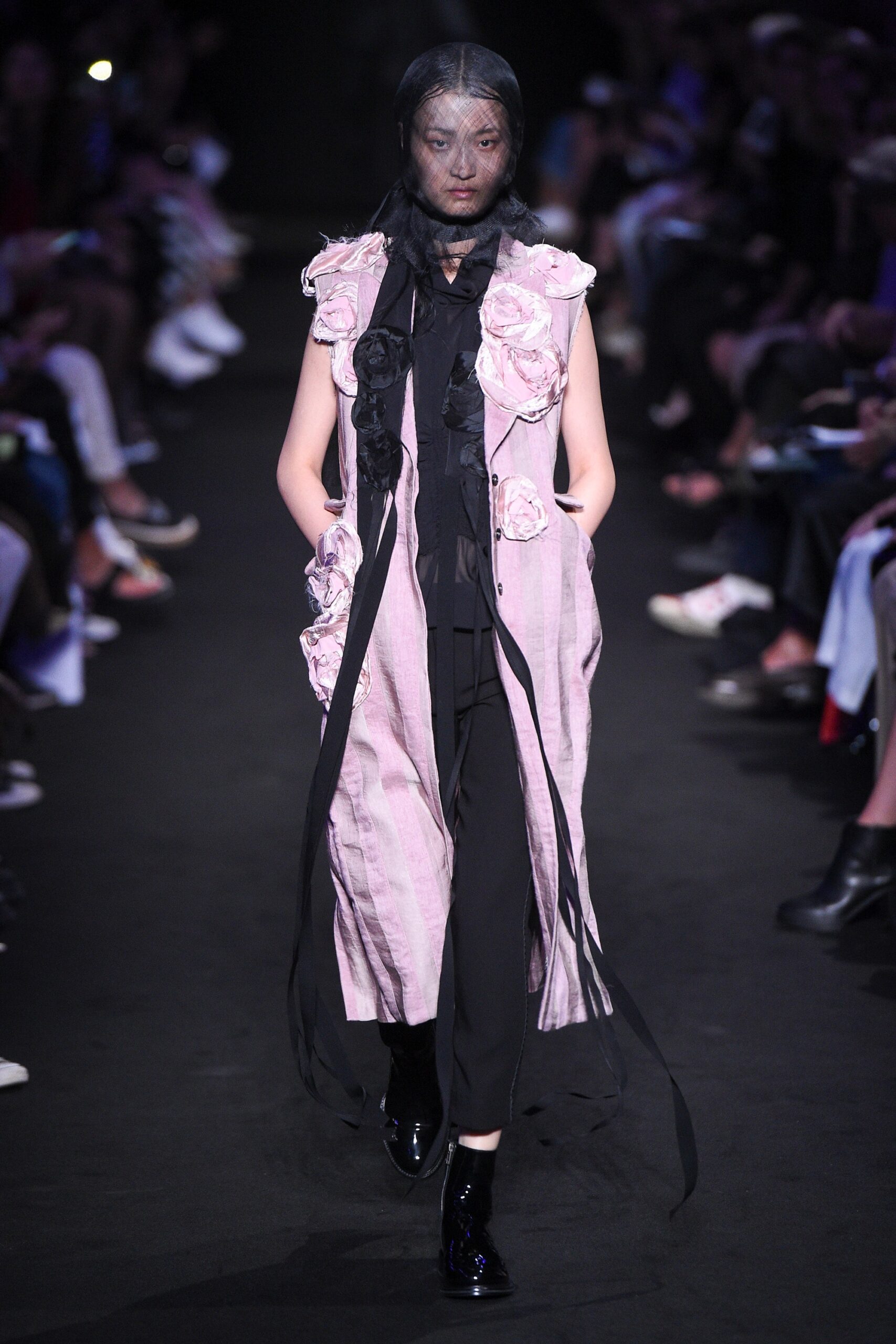 pink embroidered vest with black pants