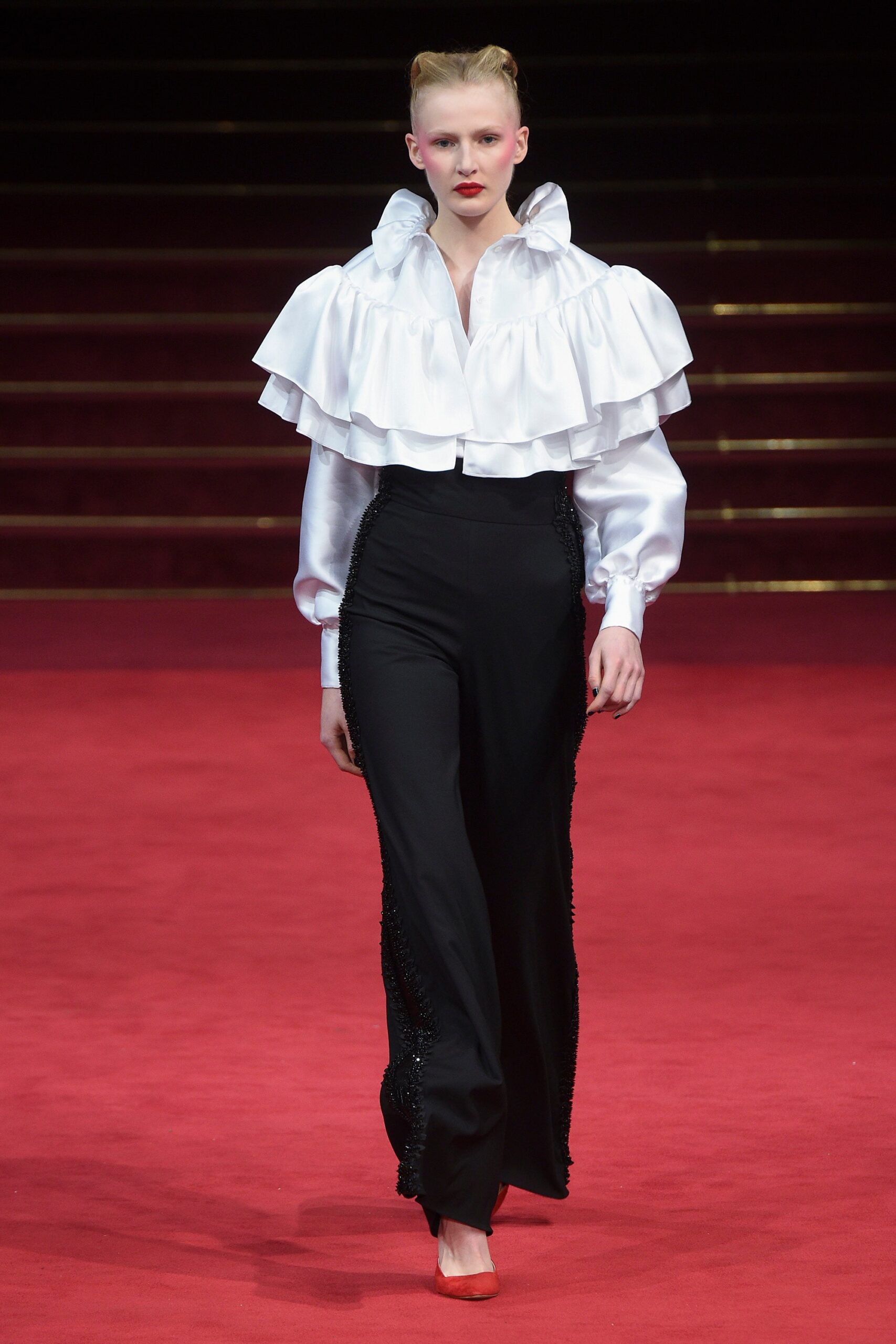 white ruffled blouse and black pants