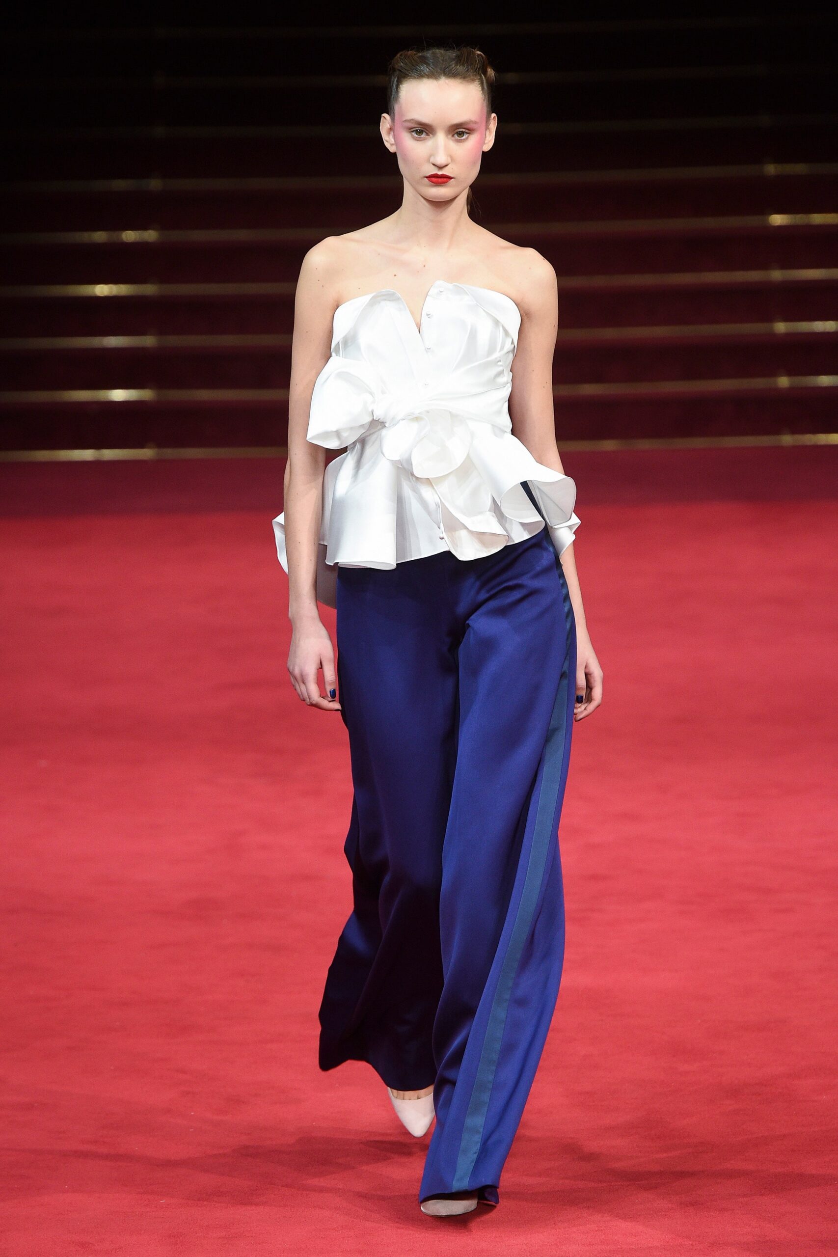 white ruffled top with blue pants