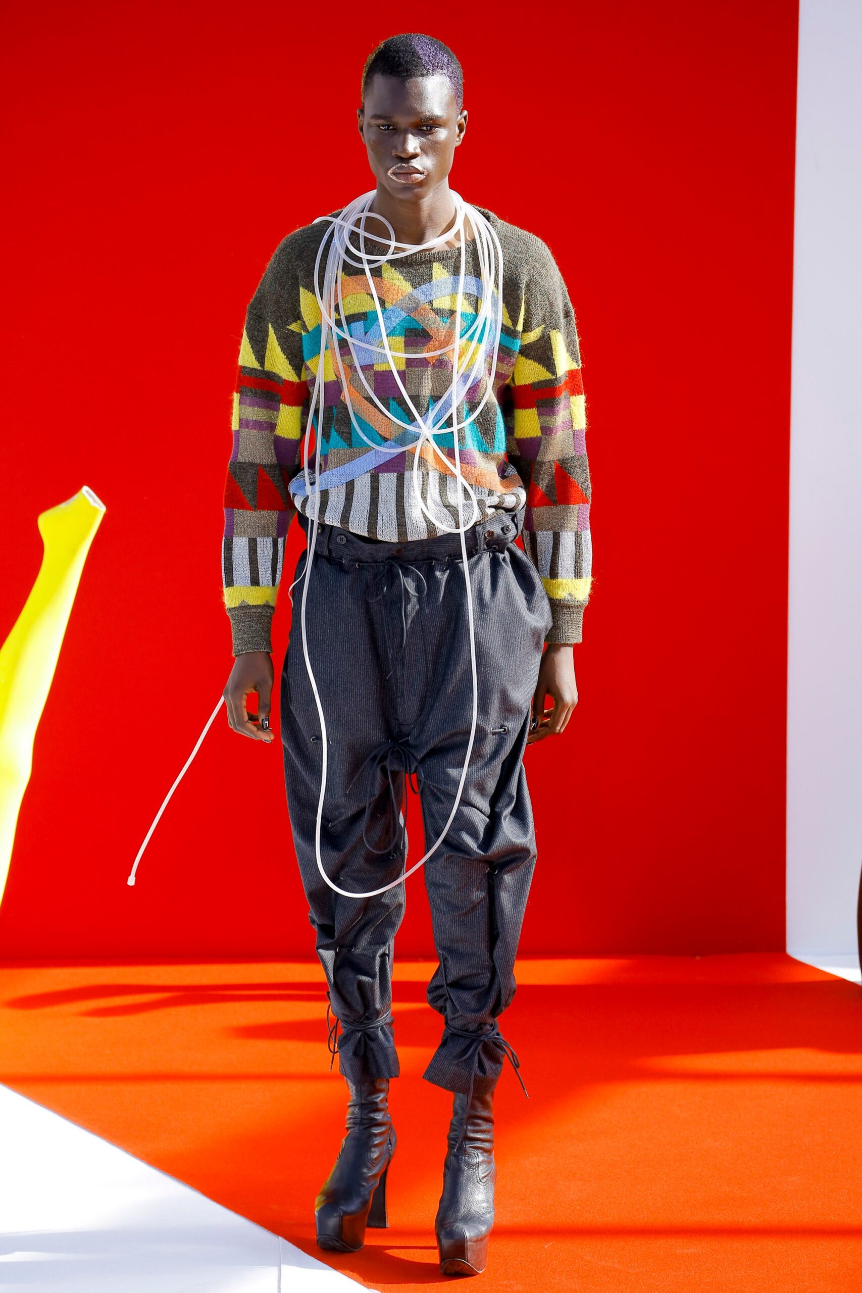 multi-patterned relaxed sweater and black pants