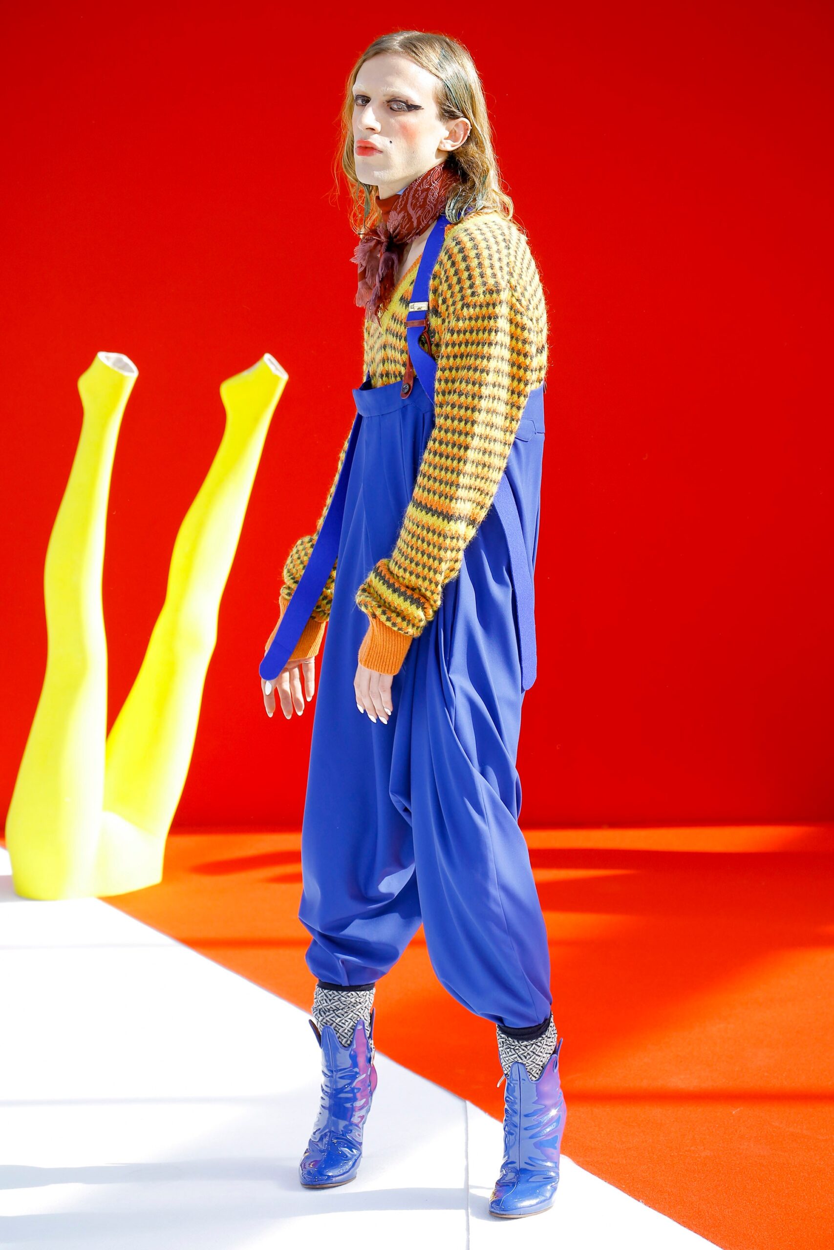 relaxed orange knit sweater with blue overalls