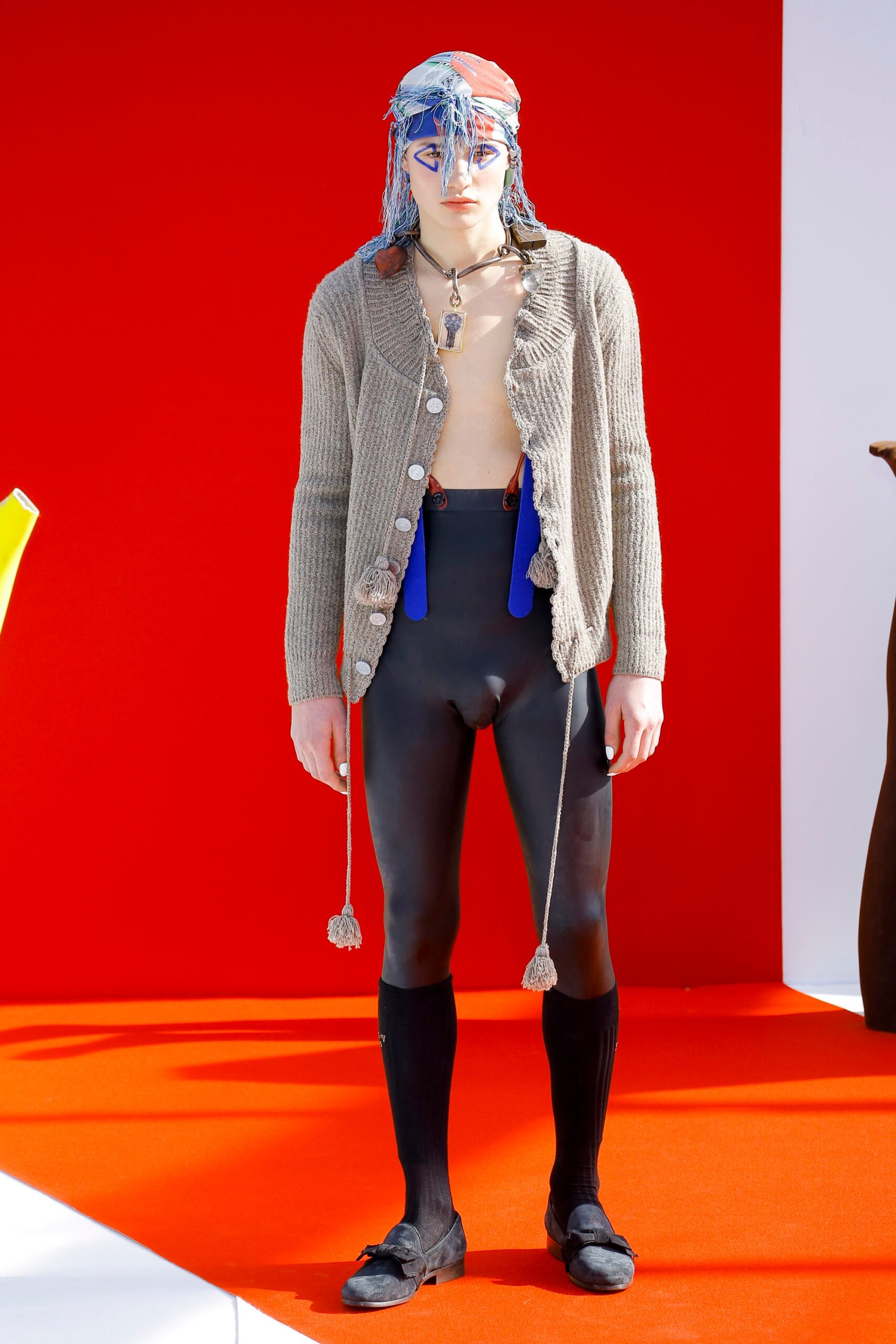 beige wool cardigan and black vinyl pants