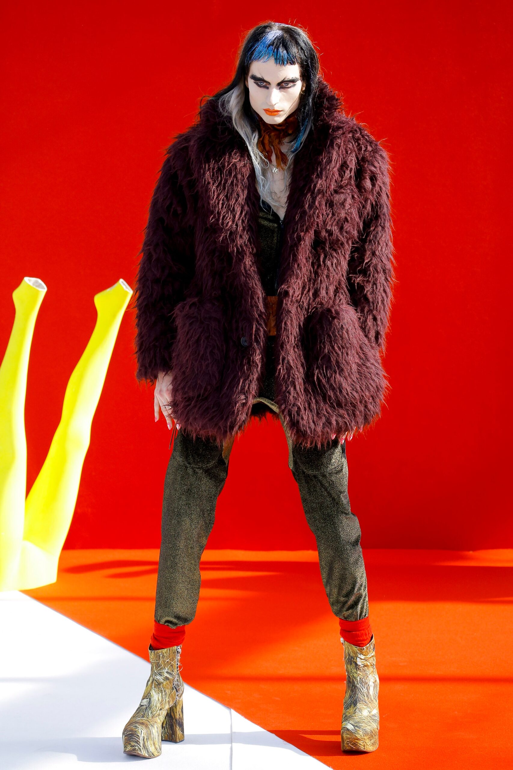 maroon faux-fur coat with green velvet pants