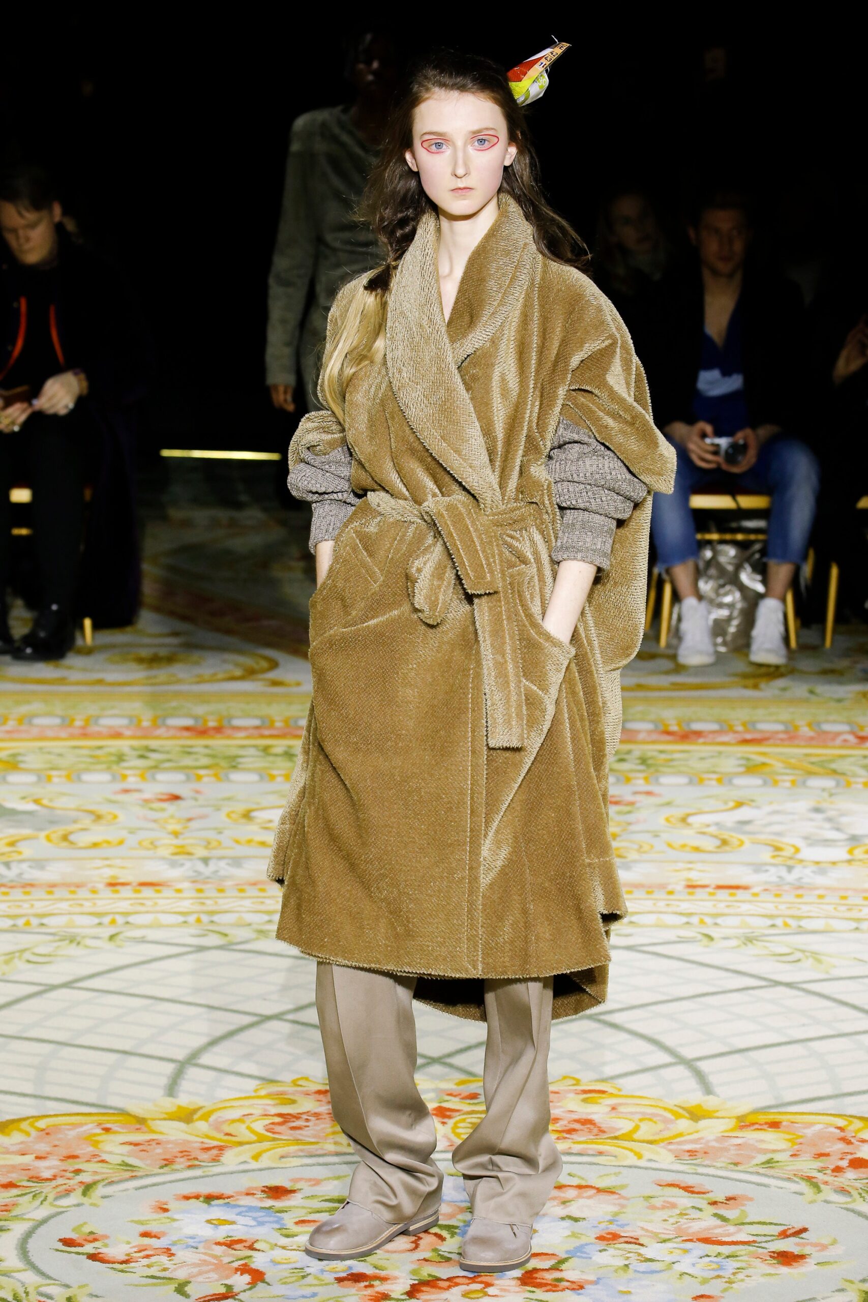 brown faux-fur belted coat with beige pants
