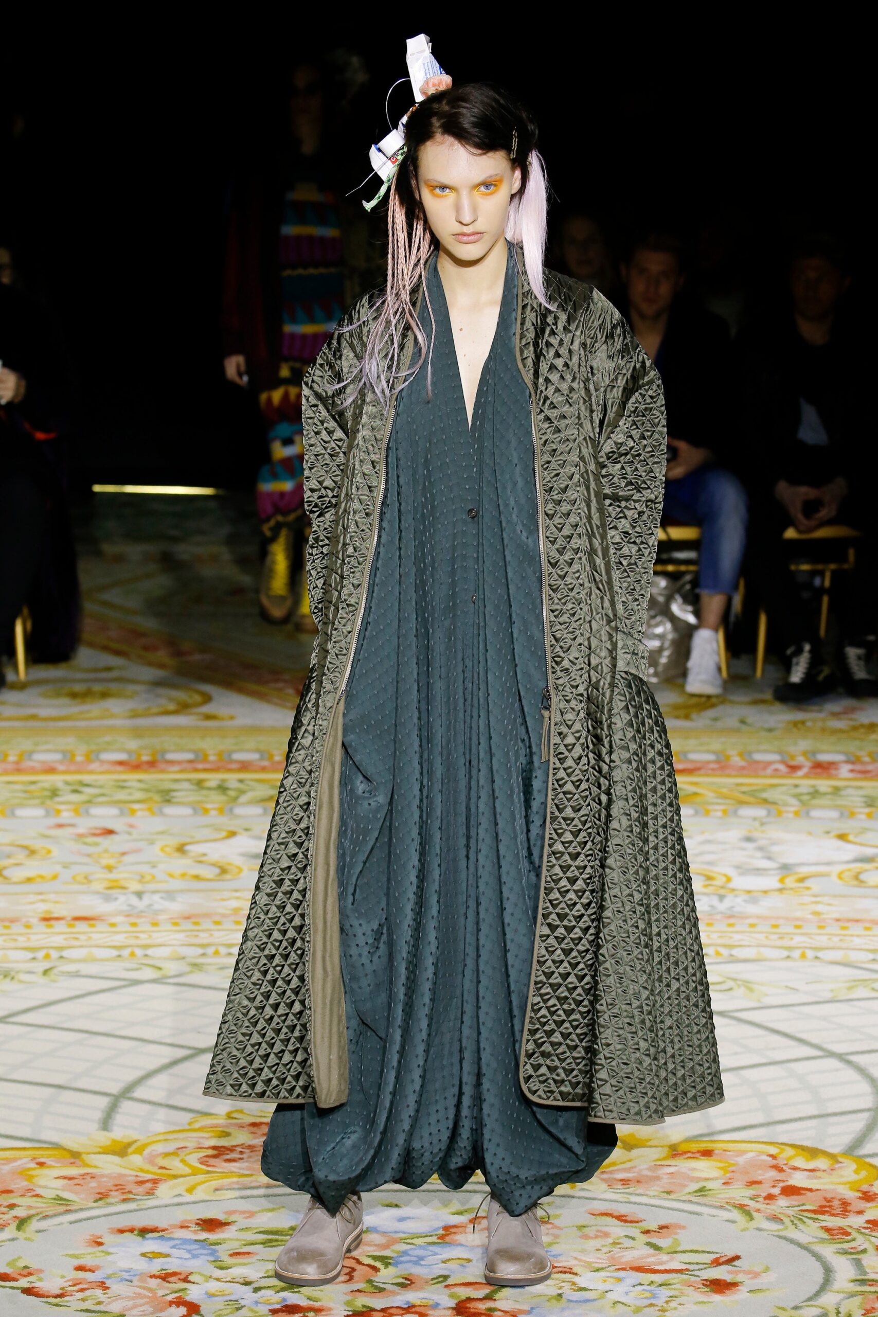 green quilted coat and blue draped dress