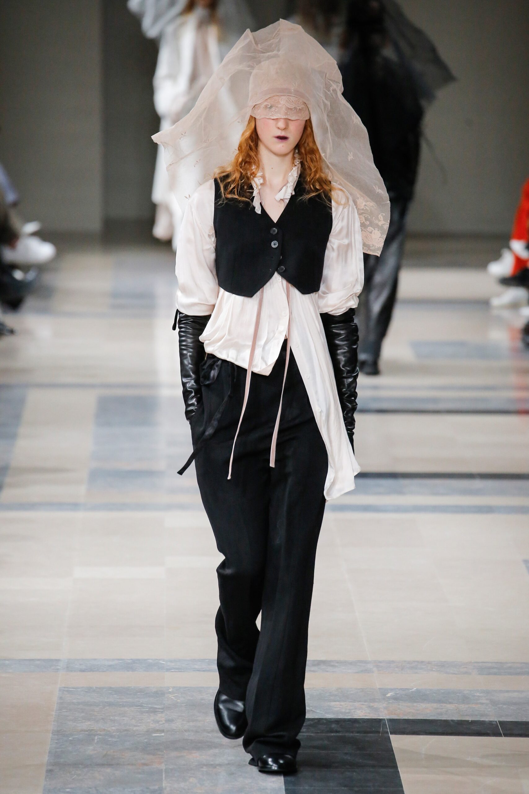 white blouse black vest and pants