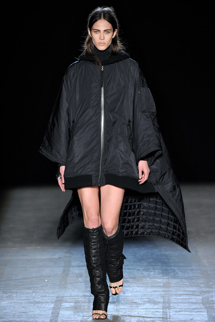 black poncho and fitted boots