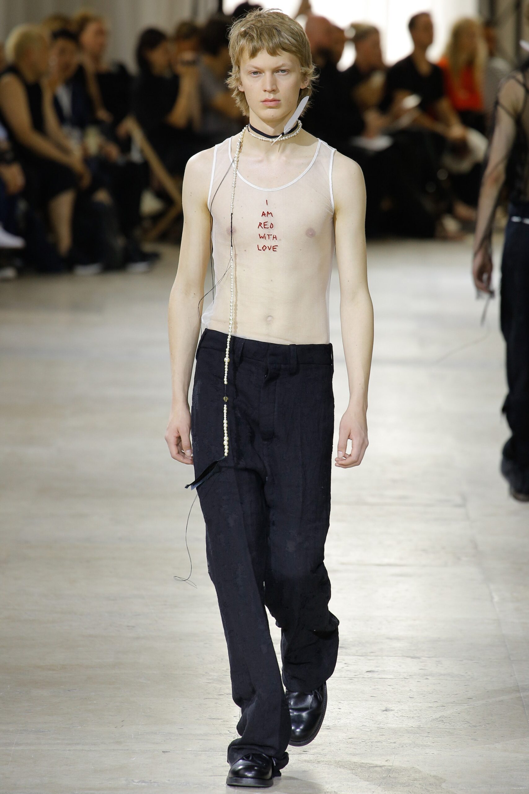 fitted white sleeveless top and relaxed black pants