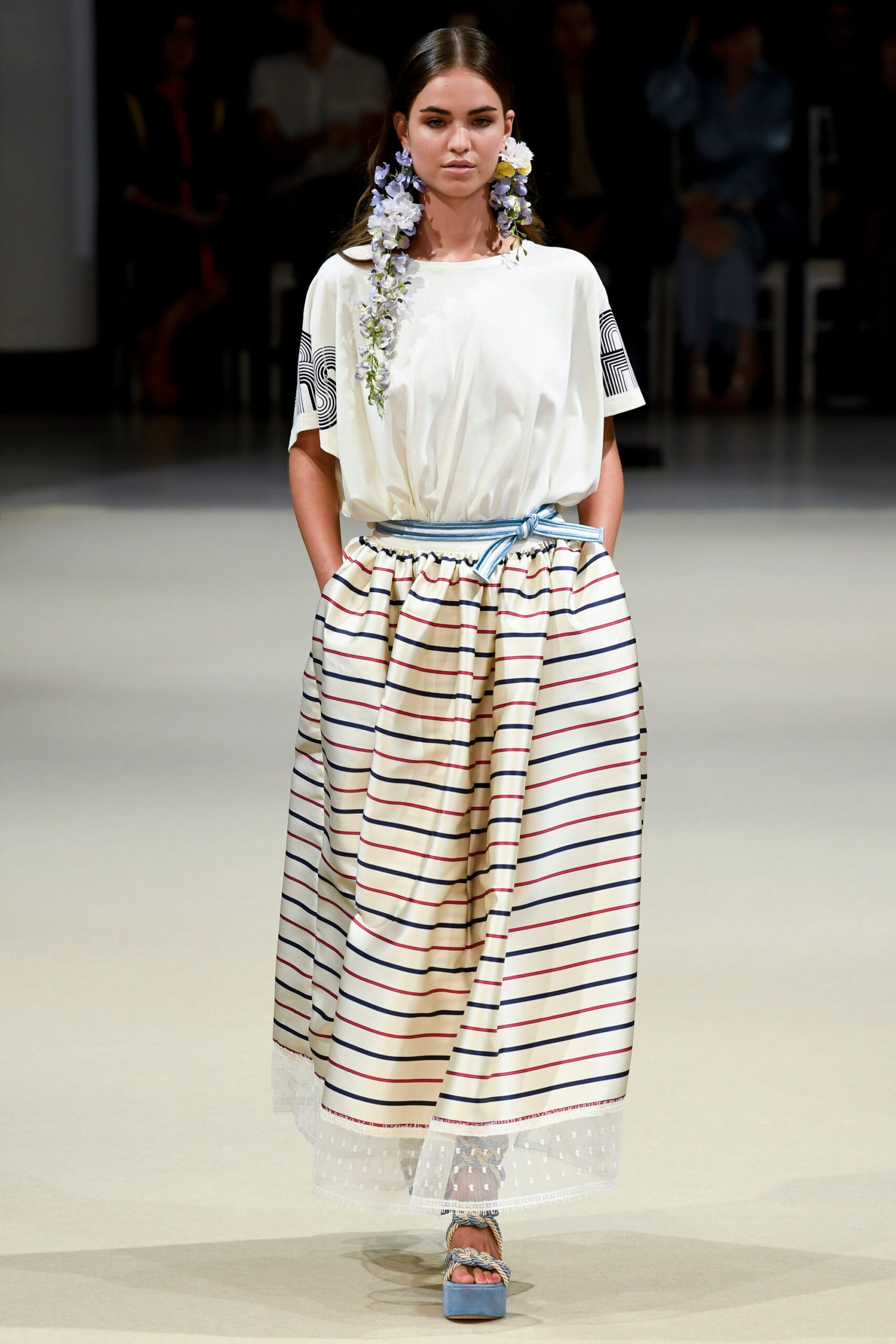 white relaxed top with beige pleated skirt