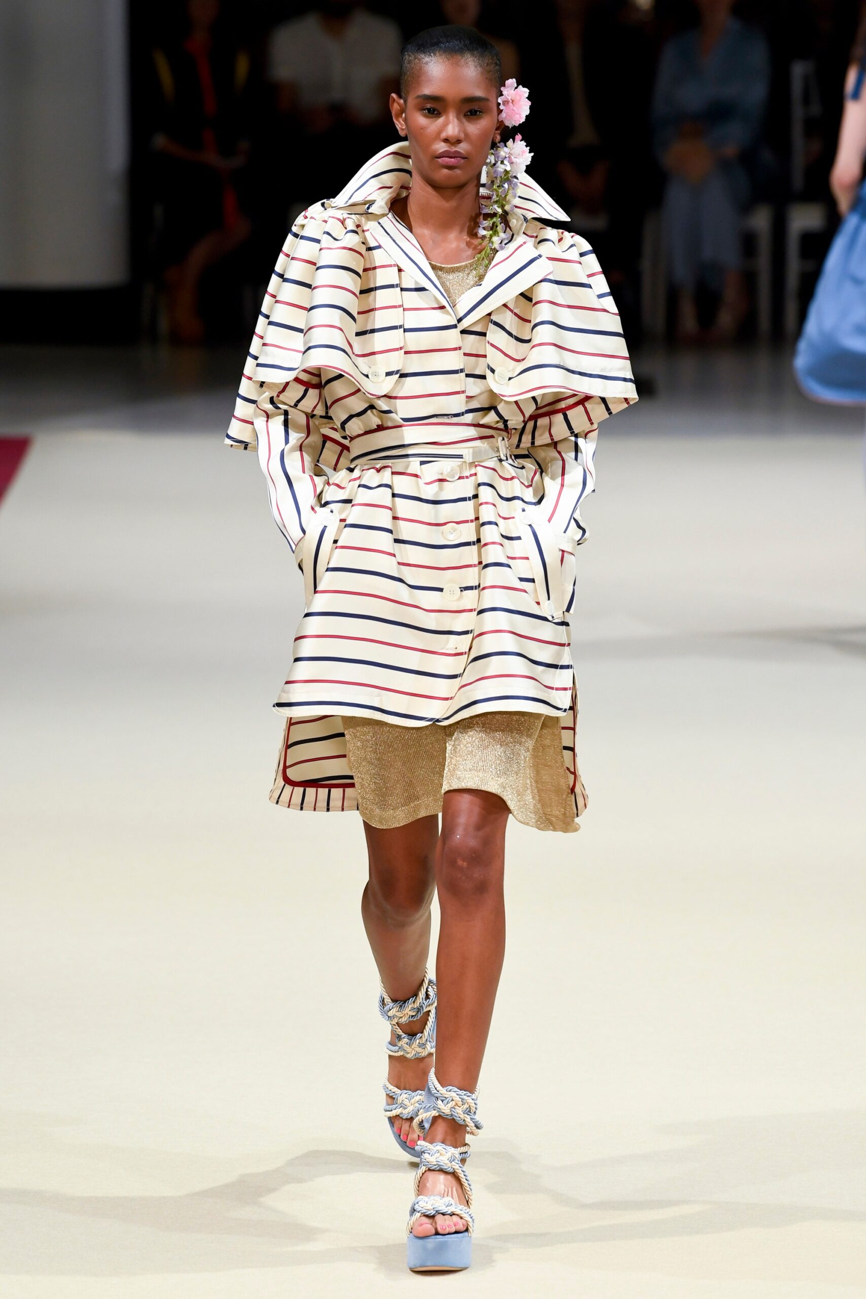 striped coat over gold dress